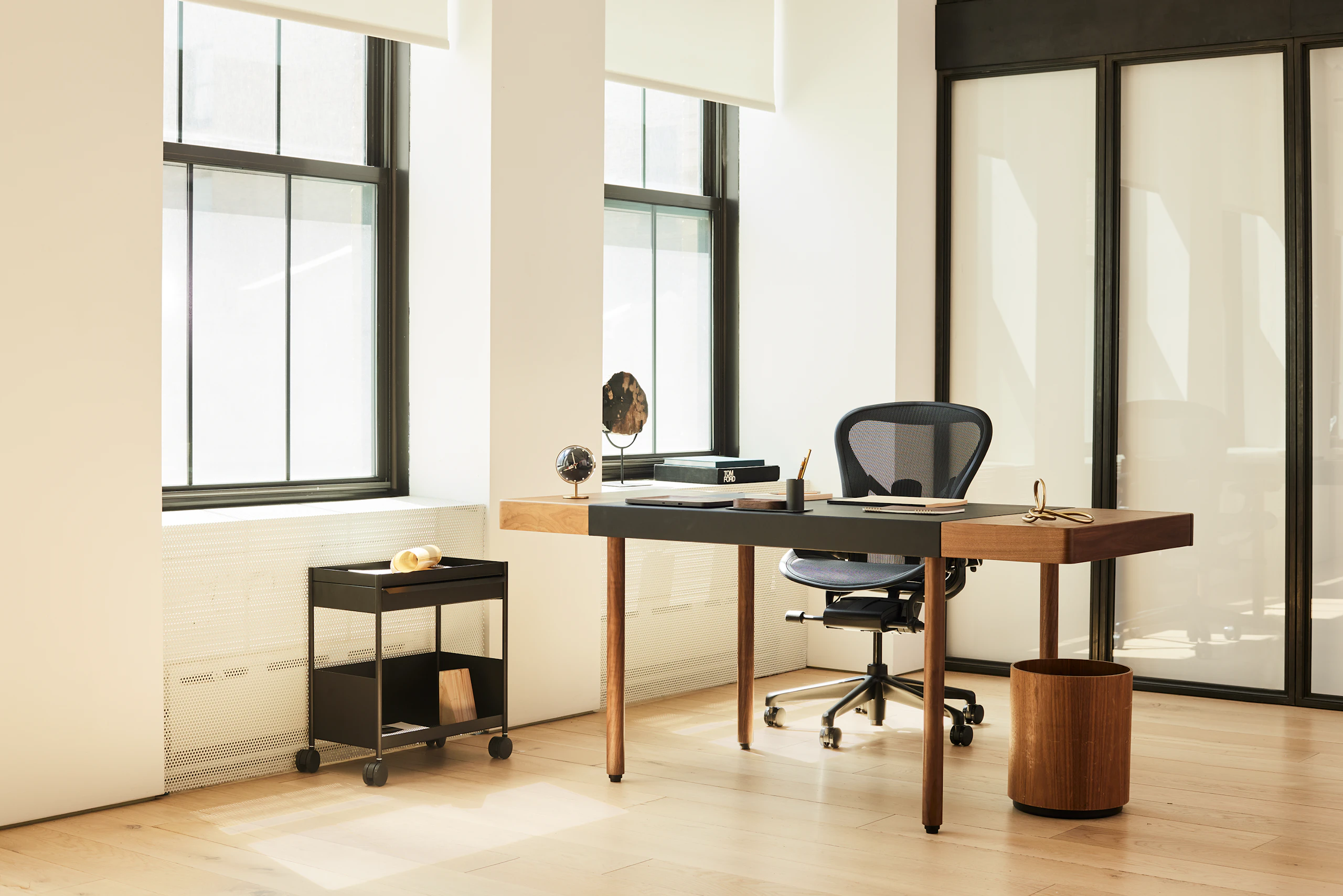 A corporate office setting with the New Canaan Leatherwrap Sit-to-Stand Desk and Aeron chair.