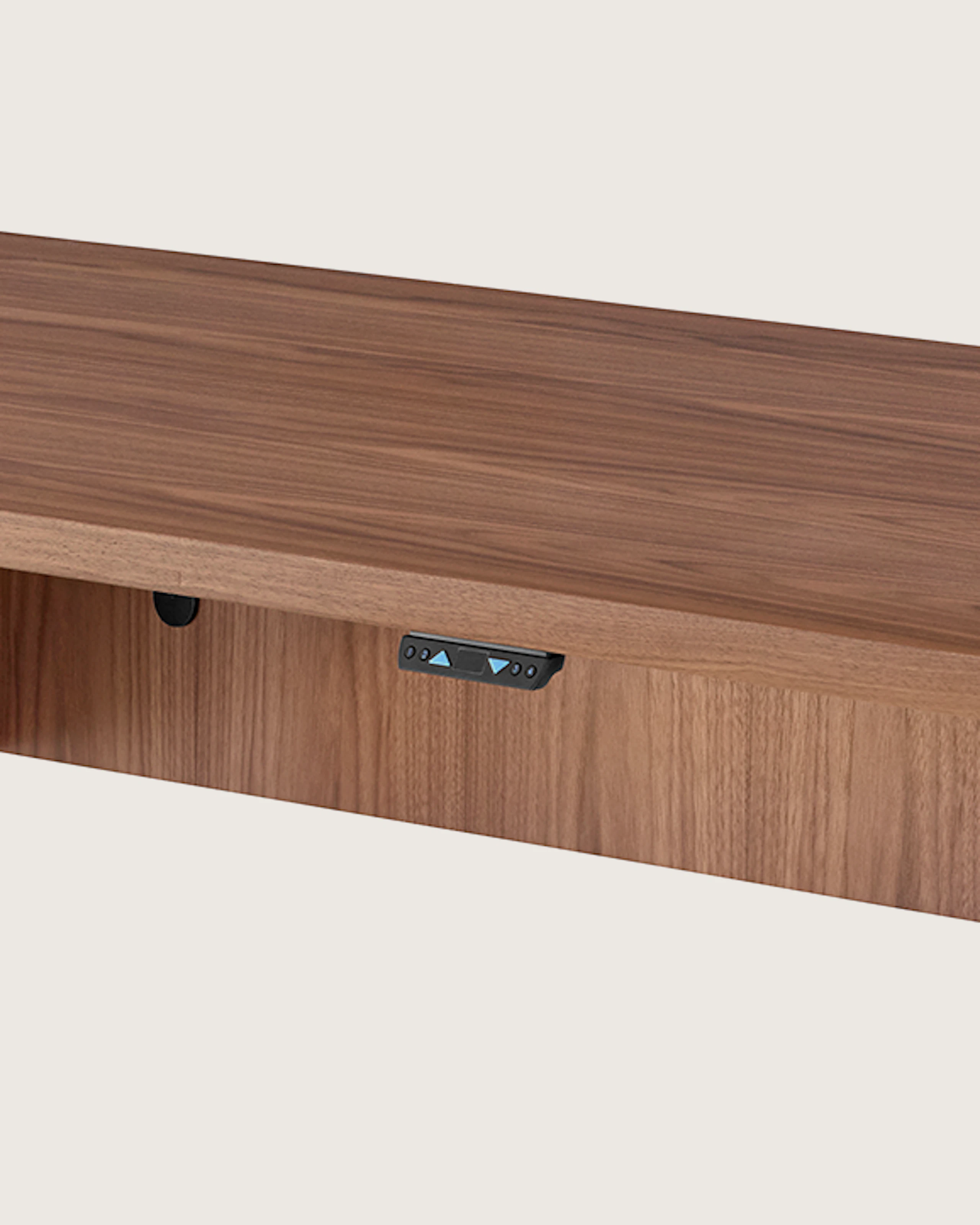 Angled view of a rectangular MP Height-Adjustable Table in a raised position, showing the height-adjustment button beneath the tabletop.