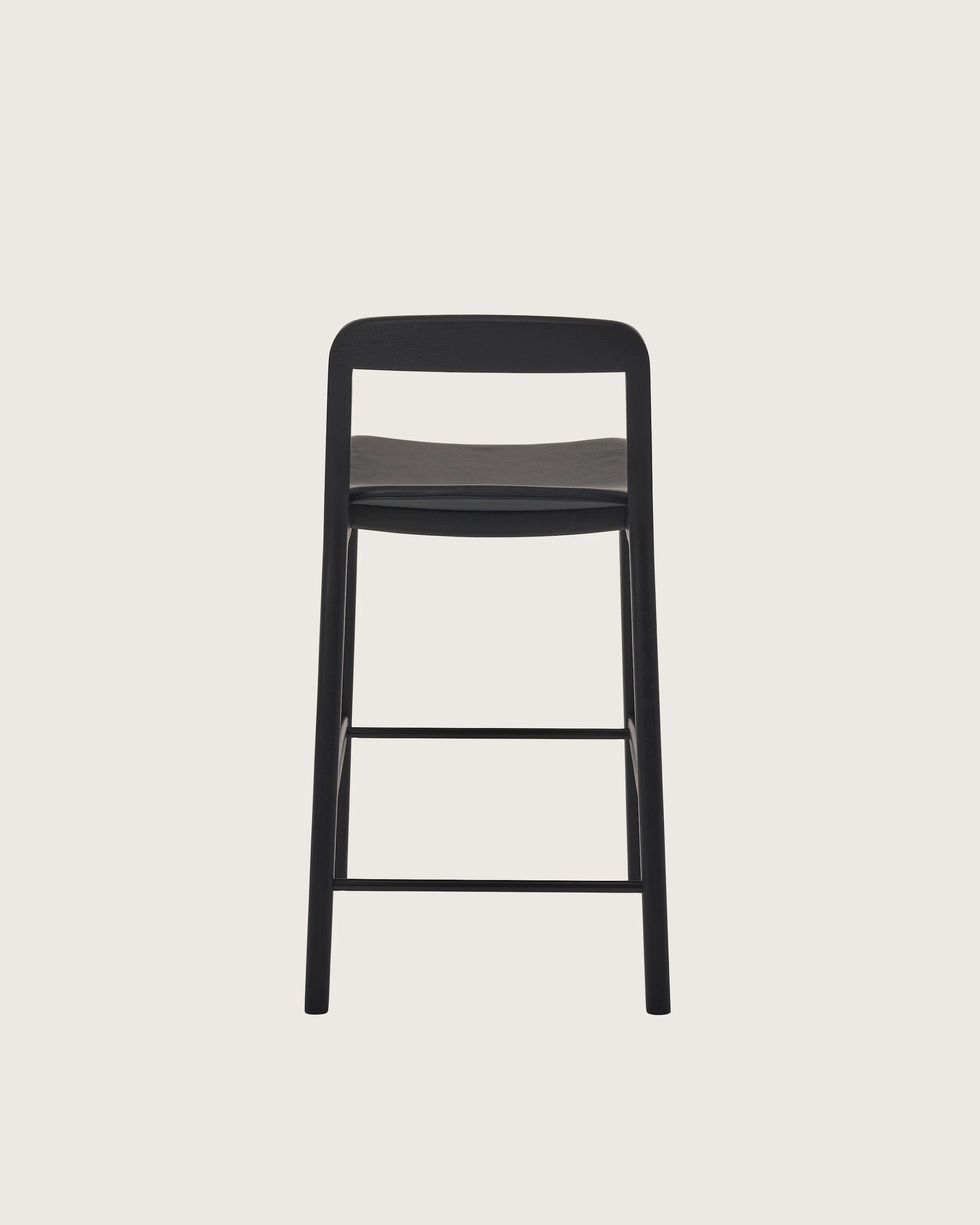 Lijn Stool by Carole Baijings for Geiger in Ebonized Oak frame upholstered with Maharam Prone Leather in Obsidian, back view on a white sweep.