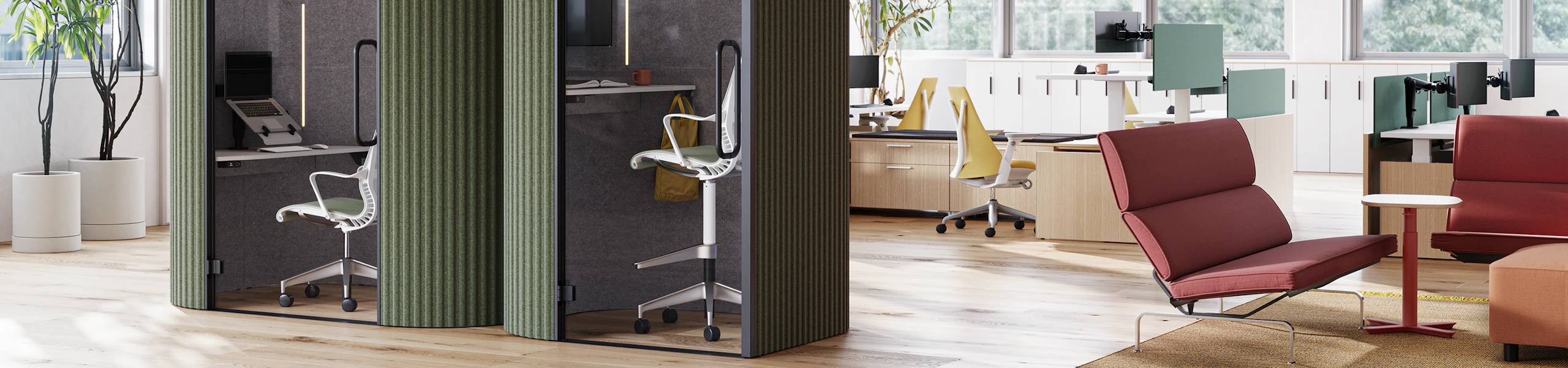 A side-by-side view of Bay Work Pod and Bay Work Pod Pro with workstations in the background and lounge setting off to the right.
