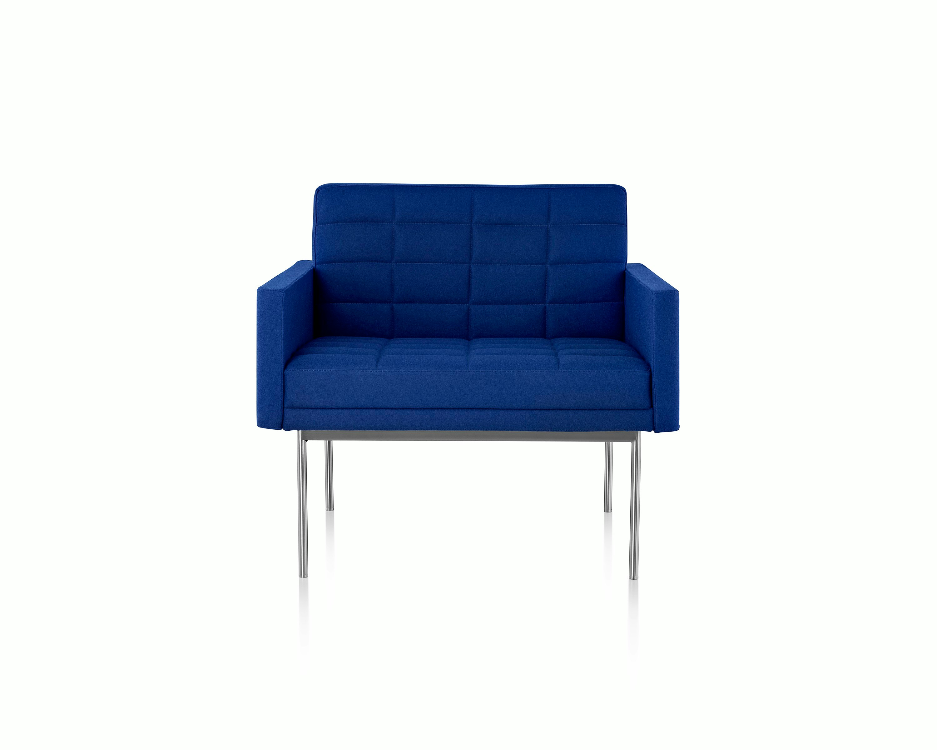 A quilted Tuxedo Component club chair upholstered in blue fabric, viewed from the front.