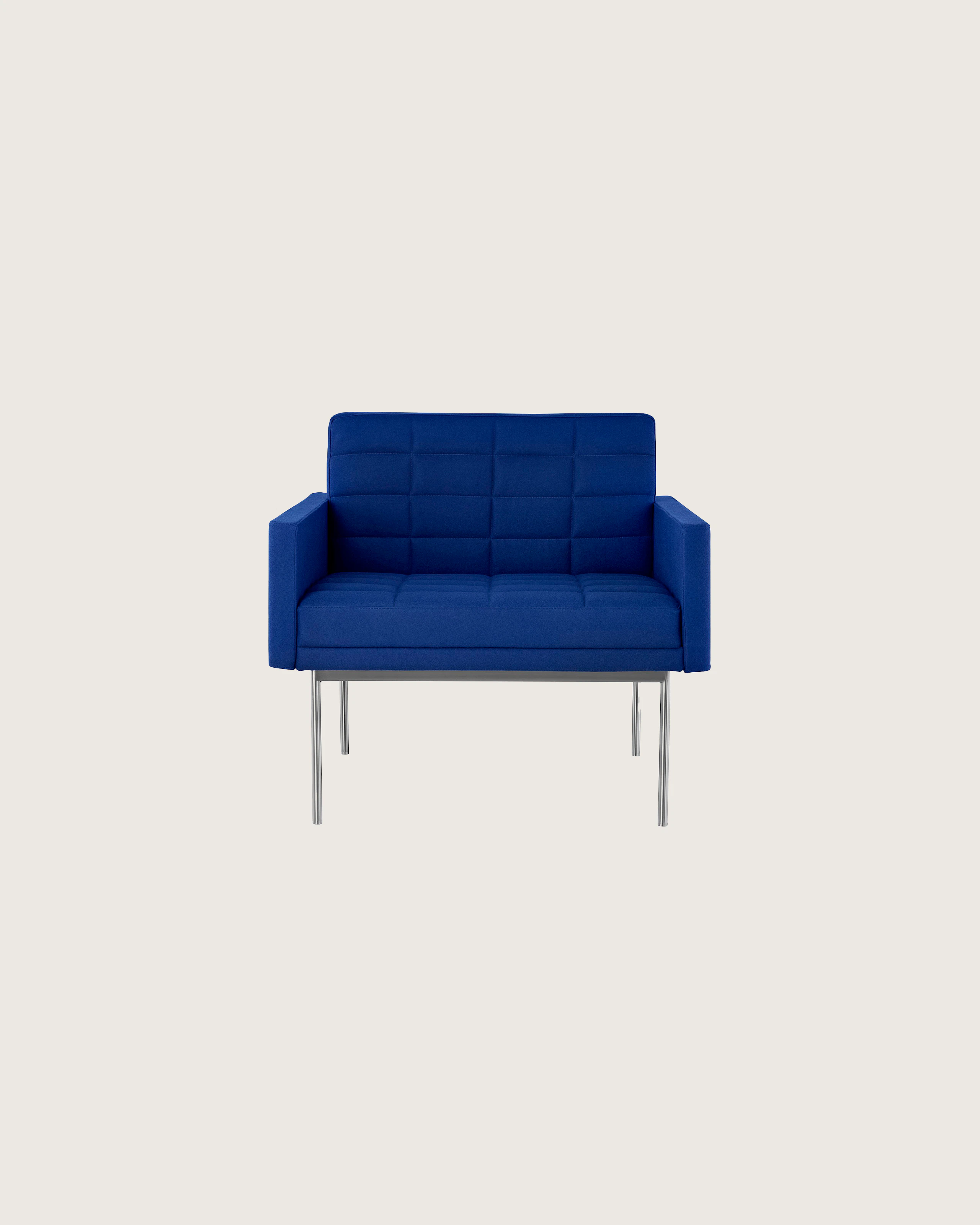 A quilted Tuxedo Component club chair upholstered in blue fabric, viewed from the front.