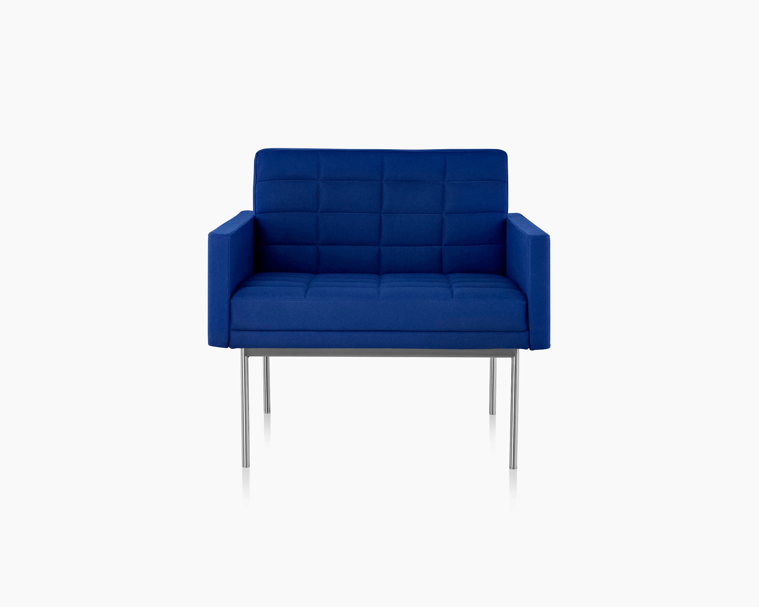 A quilted Tuxedo Component club chair upholstered in blue fabric, viewed from the front.