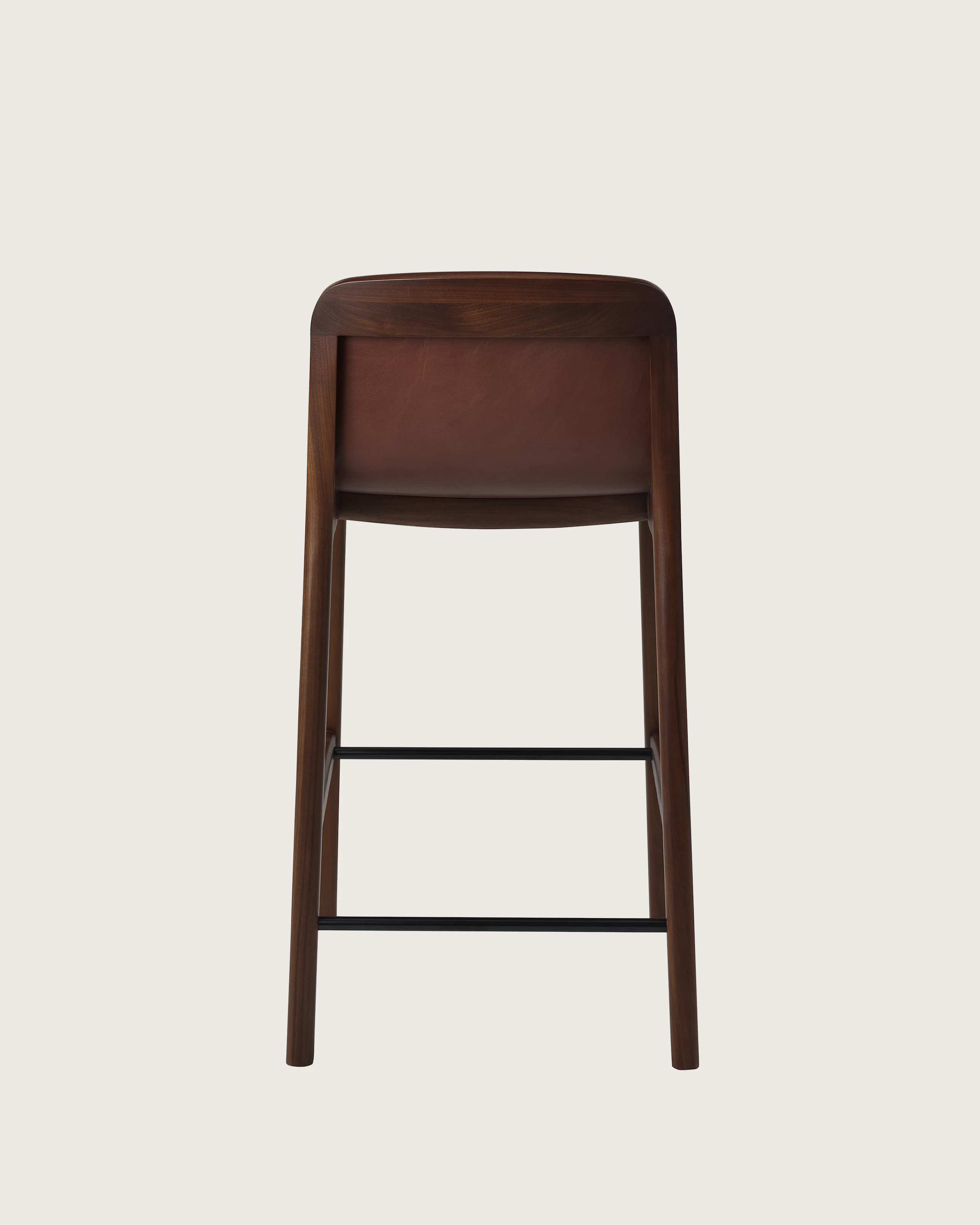 Lijn Stool by Carole Baijings for Geiger in Persian Walnut frame upholstered with Maharam Hue Leather in Bittersweet, back view on a white sweep.