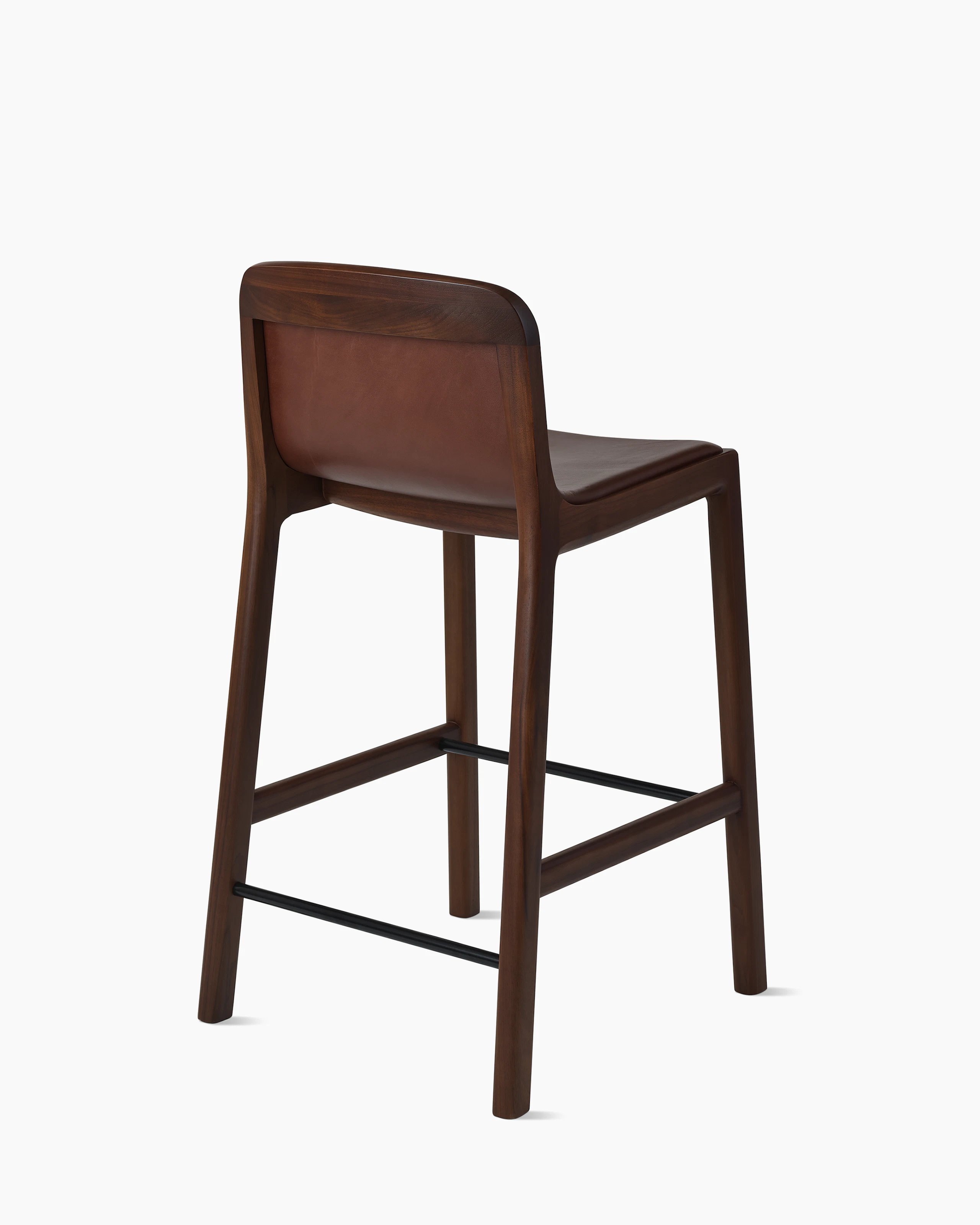 Lijn Stool by Carole Baijings for Geiger in Persian Walnut frame upholstered with Maharam Hue Leather in Bittersweet, angled back view on a white sweep.