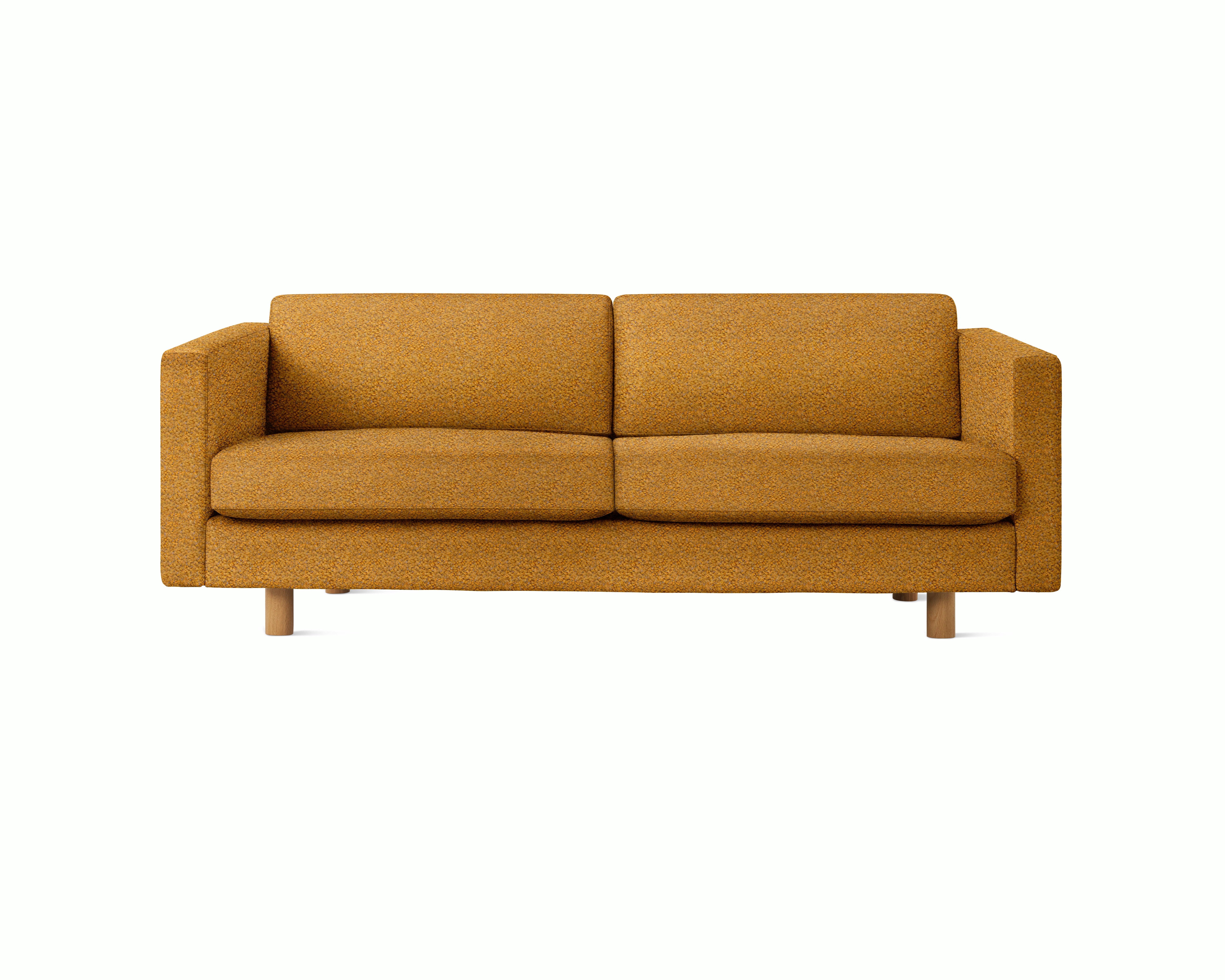A Lispenard Sofa in Mustardseed upholstery with oak legs viewed from the front.
