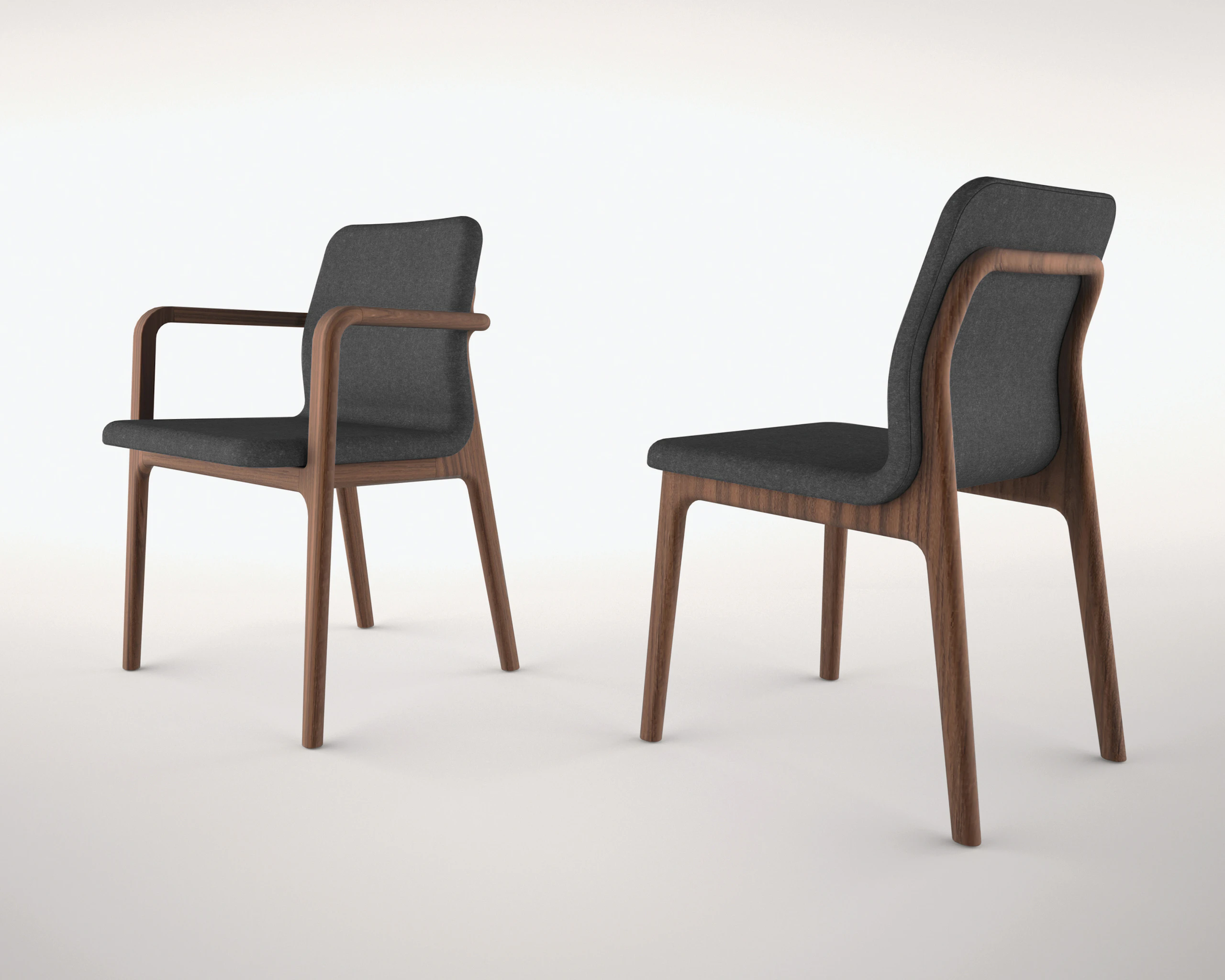 A Deft side chair with arms and black fabric, viewed from behind at an angle, next to an armless Deft side chair with black fabric, viewed from the side.