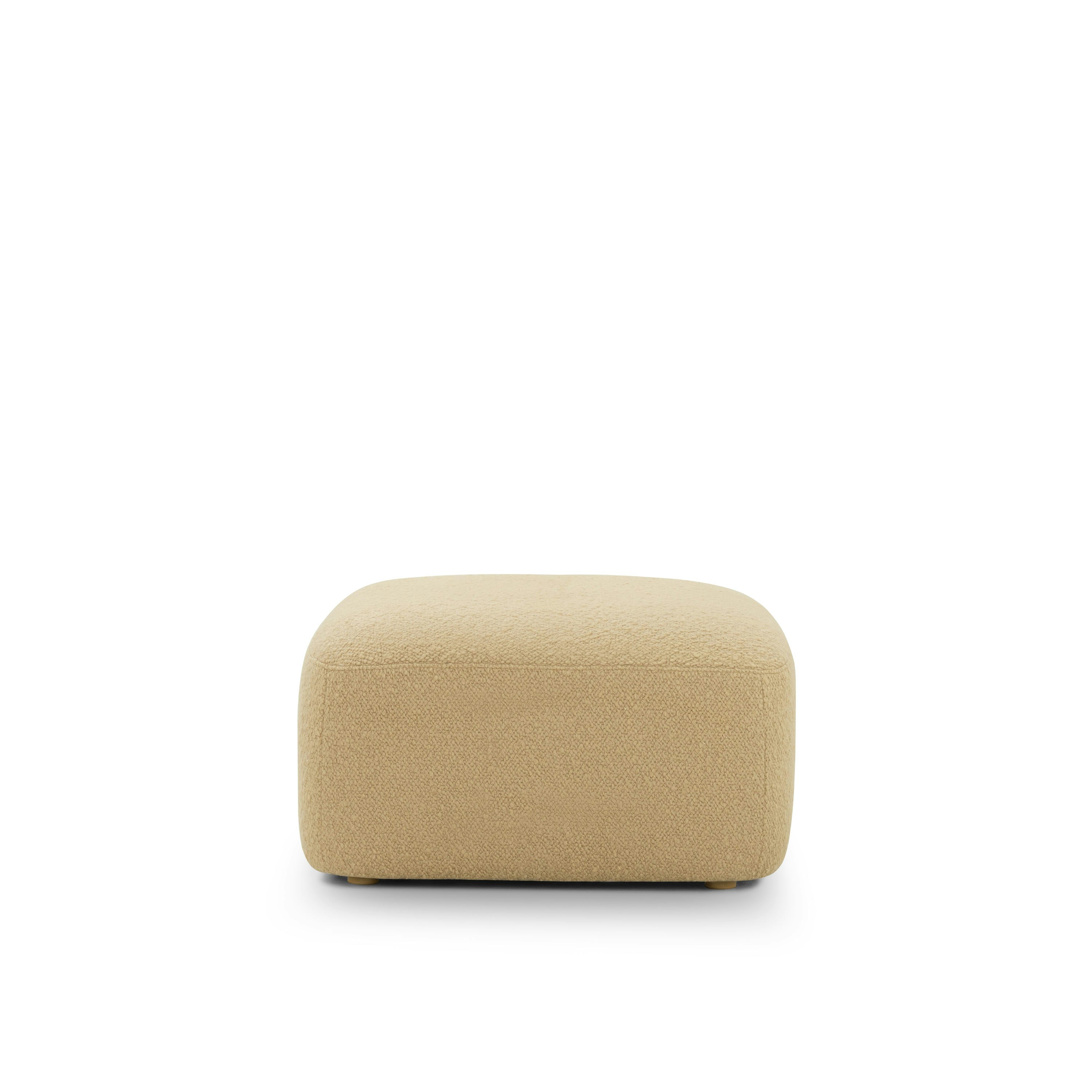 A Muse Ottoman in Airlie: Camel viewed from the front.