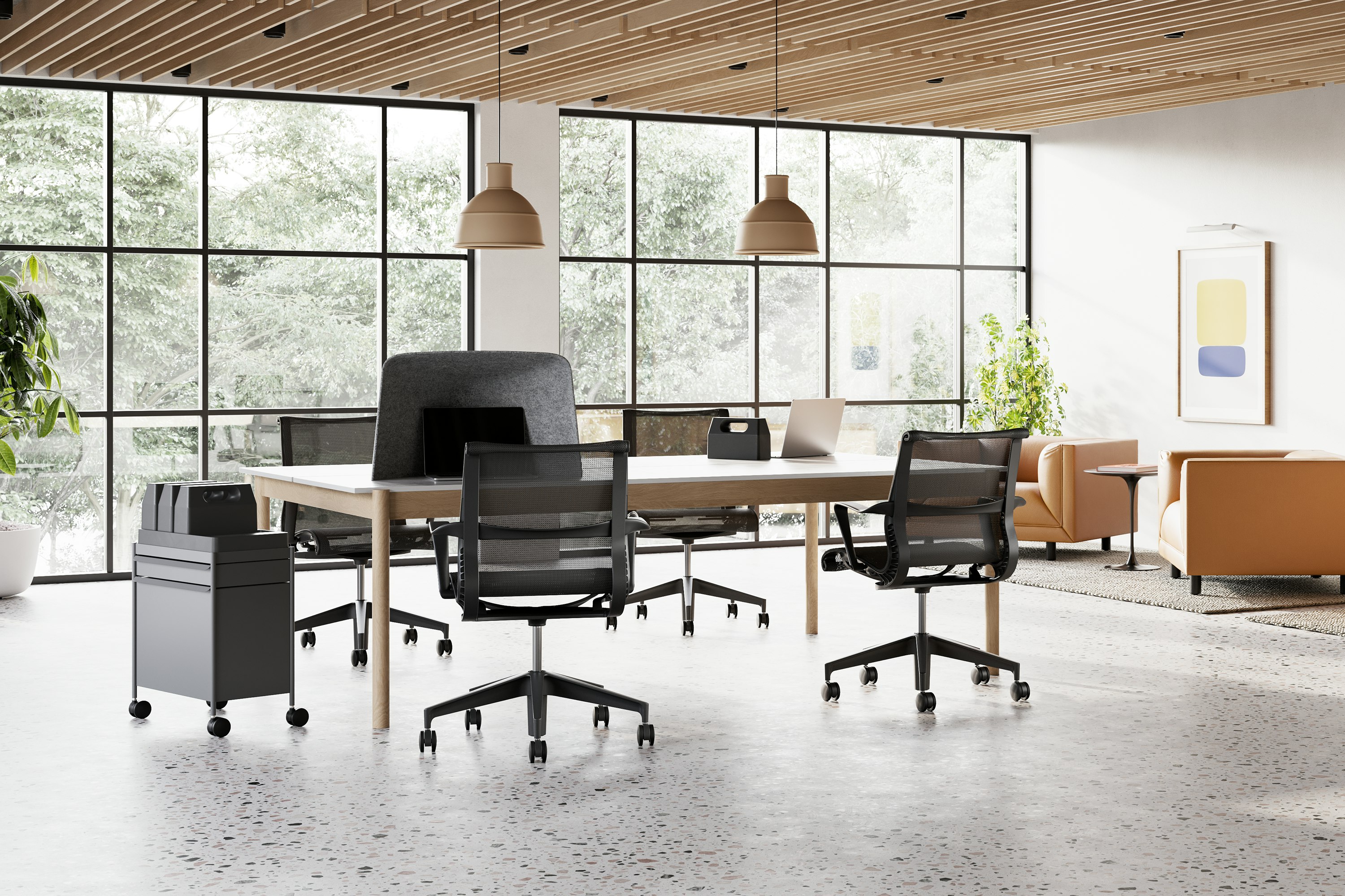 Four Setu chairs in grey surround a table in a larger study hall space.