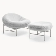 White lounge chair and ottoman on a plain background.
