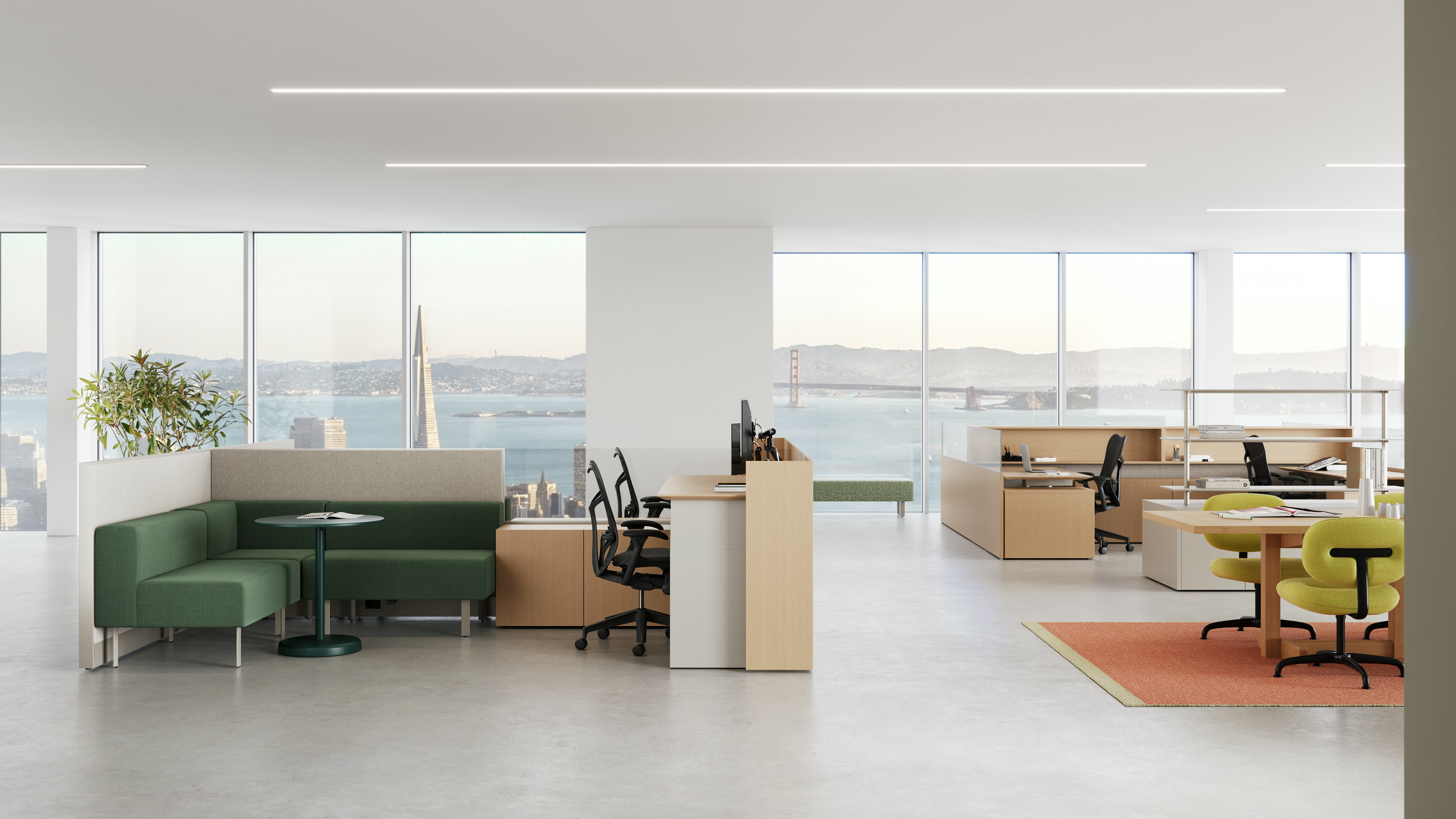 An open office shows various work points with workstations, a meeting table, shared storage and lounge seating.