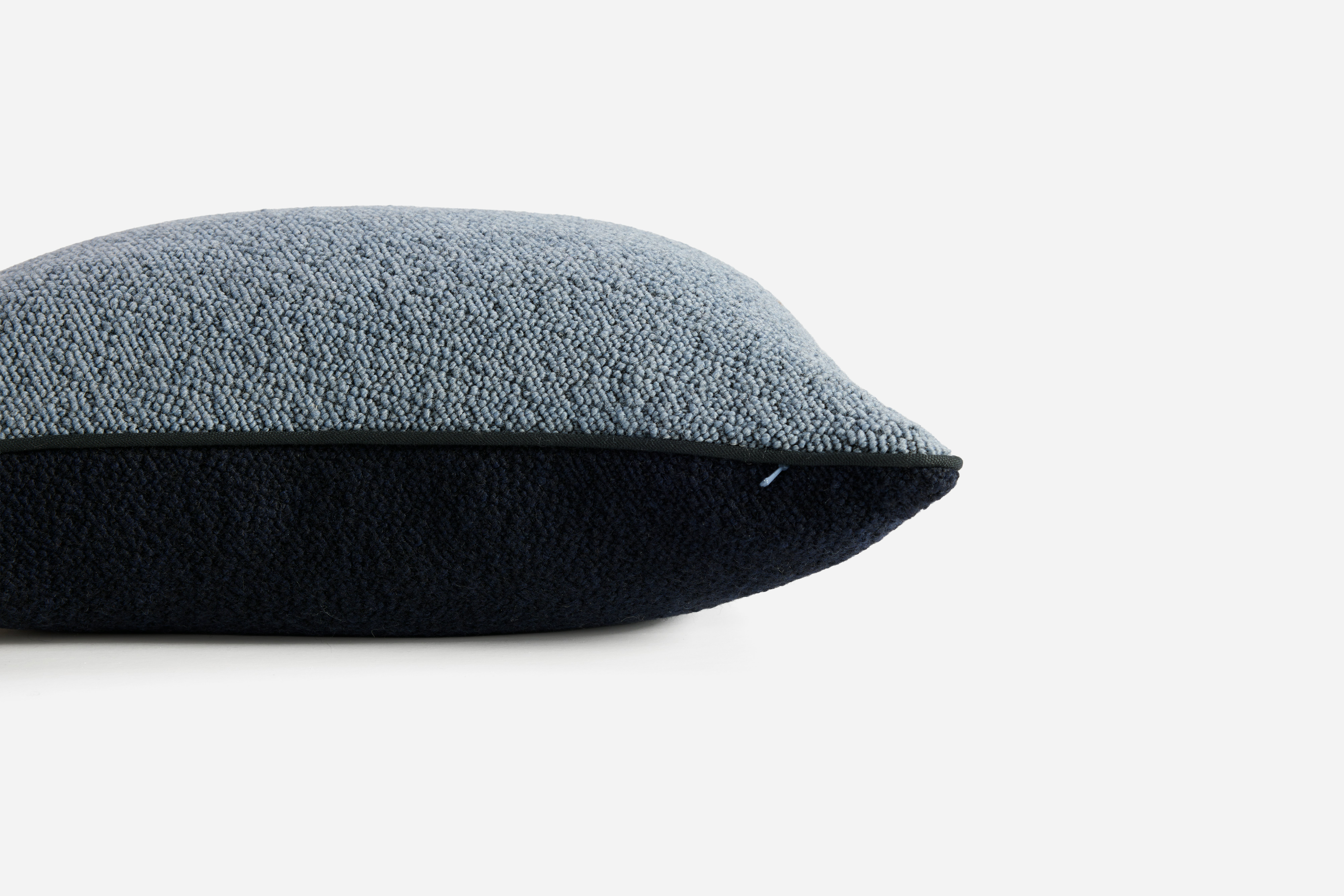 A detailed look at a Turf Color Blocked Pillow in Blue Grey Dark Blue.