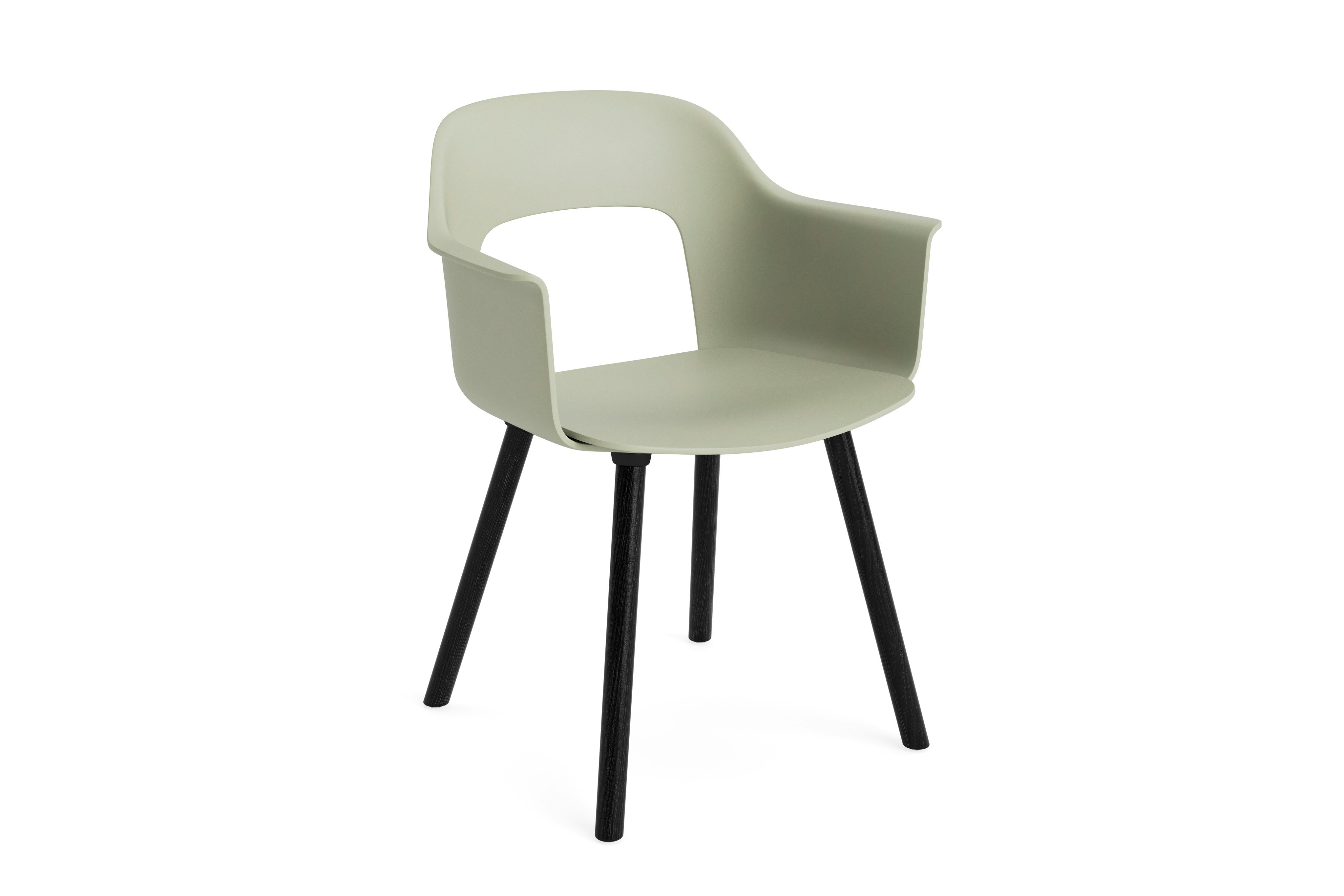 Layout Armchair 221 with pastel green plastic shell and black wood base, angled view on white background.
