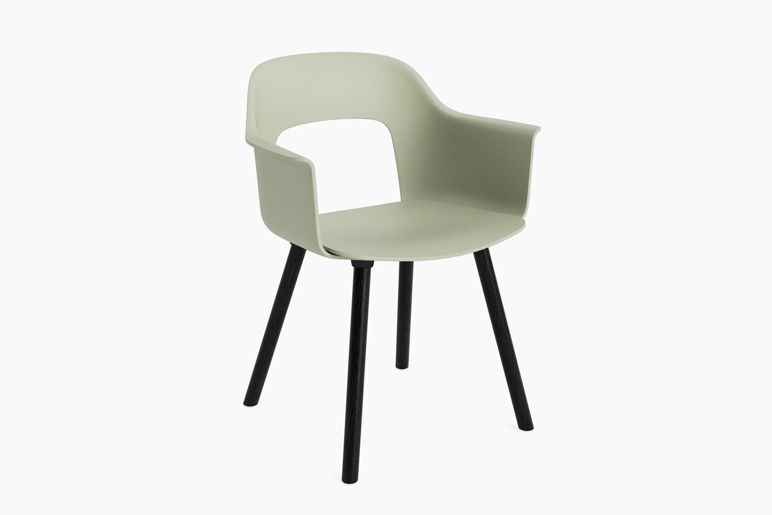 Layout Armchair 221 with pastel green plastic shell and black wood base, angled view on white background.
