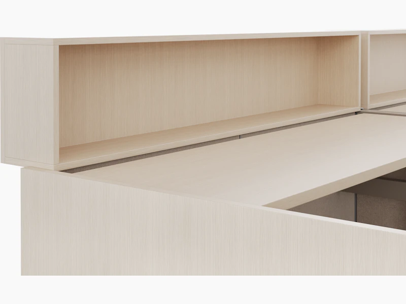 A detail rendering shown at an angle of a height adjustable work surface and personal storage cubby attached to the work surface.