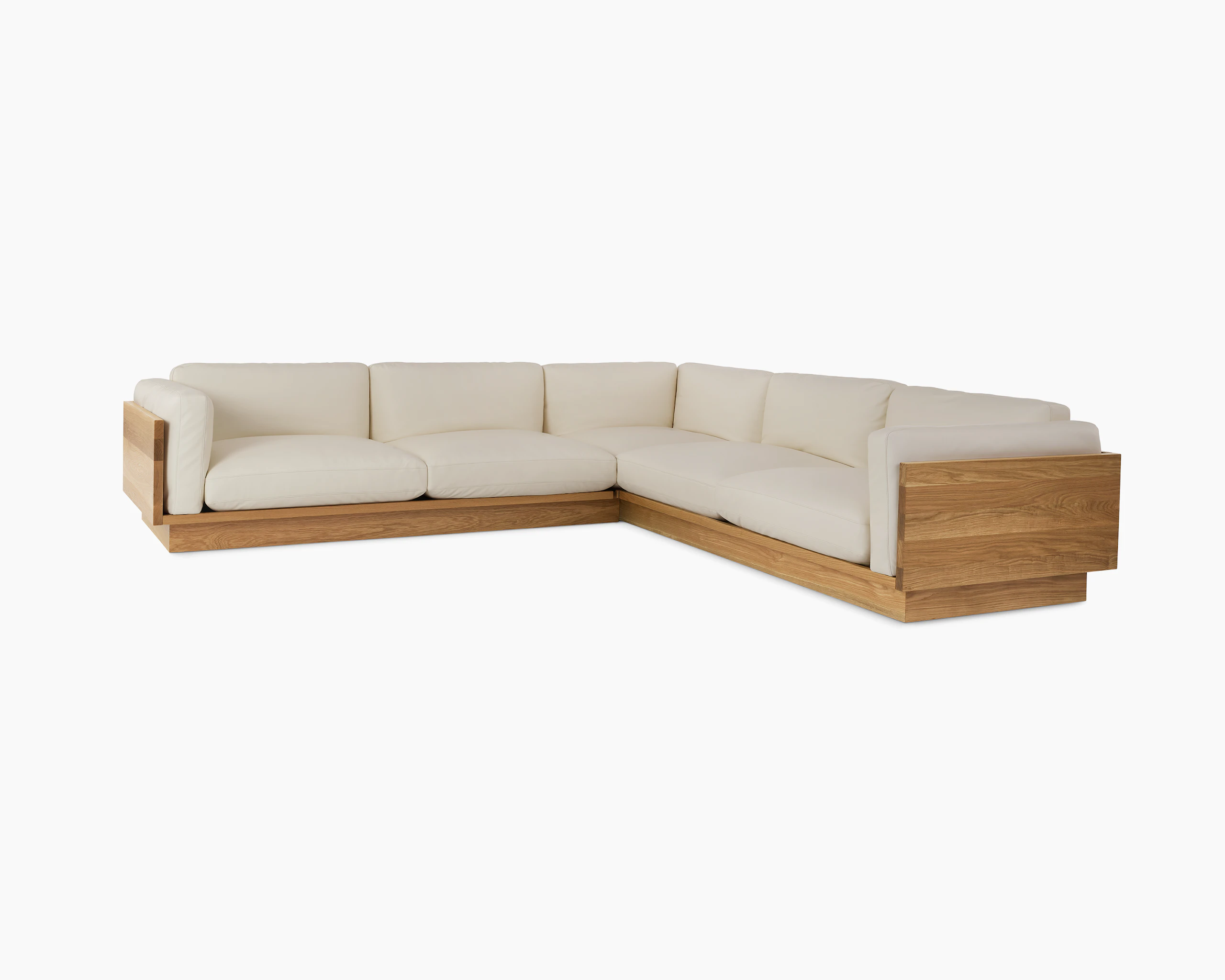 Pawson Drift Sectional Sofa with white leather upholstery and white oak base.