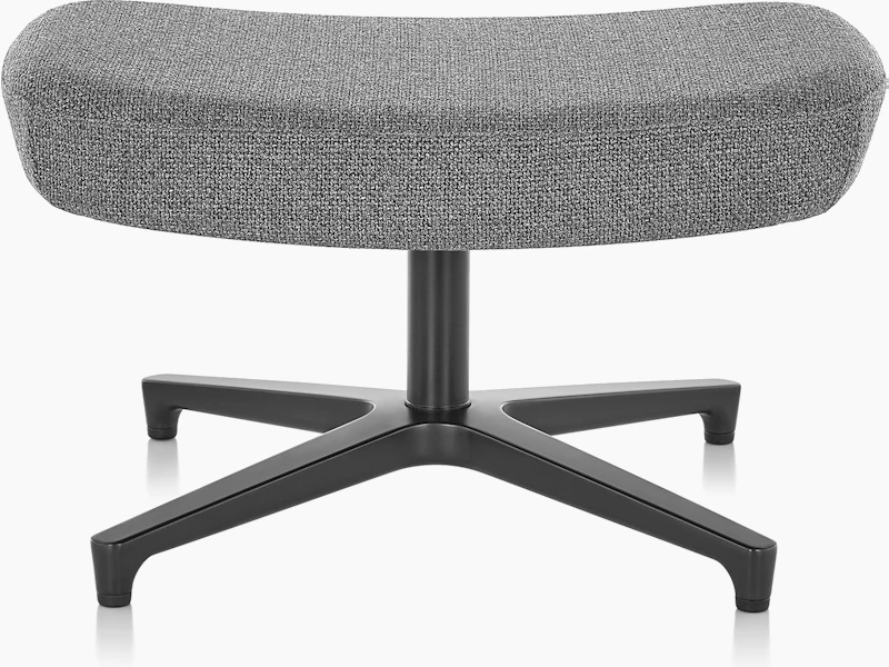 A rectangular Saiba ottoman with gray upholstery and a four-star base.