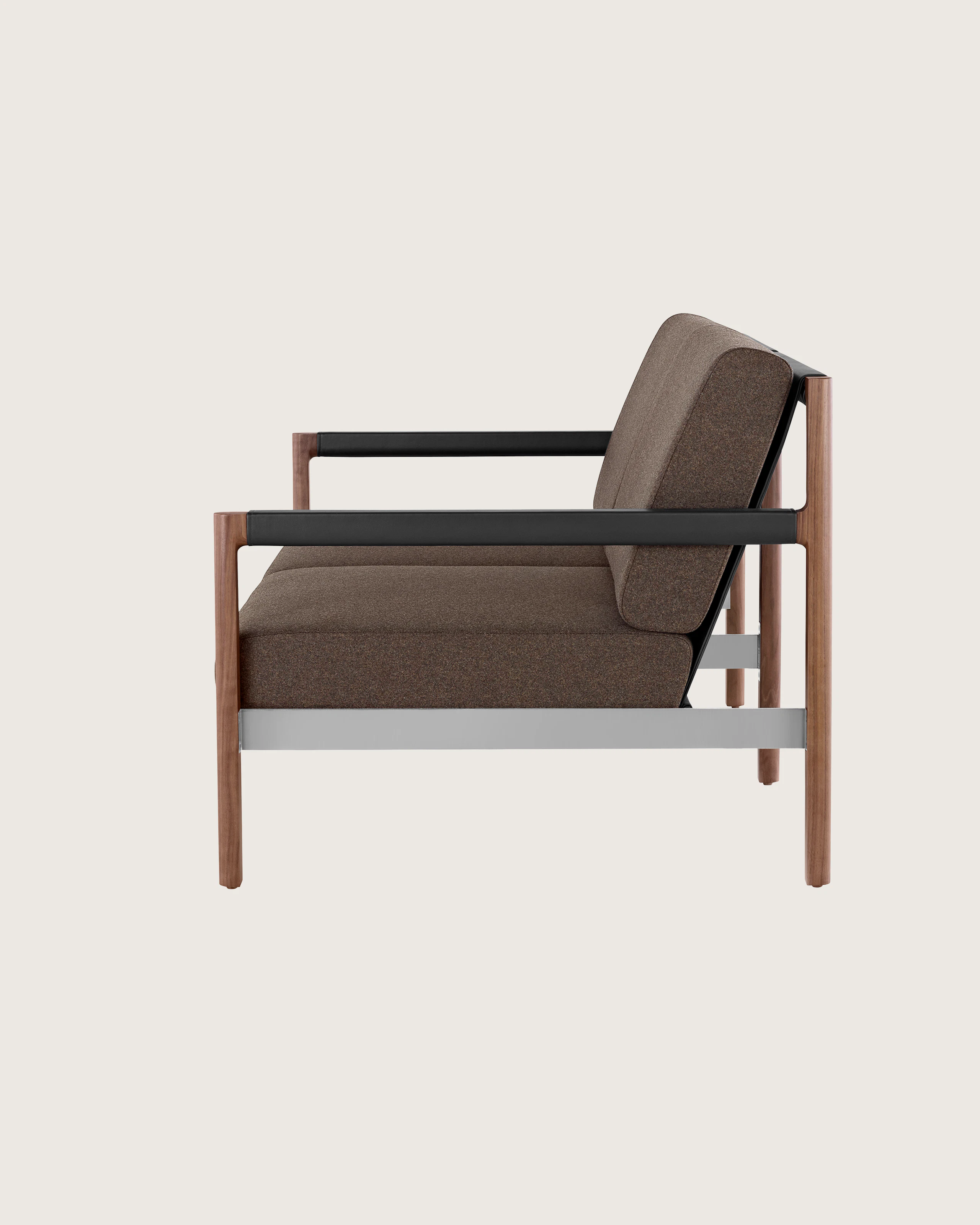 A Brabo Settee with dark upholstery, leather and metal accents, and an exposed wood frame. Viewed from the side.