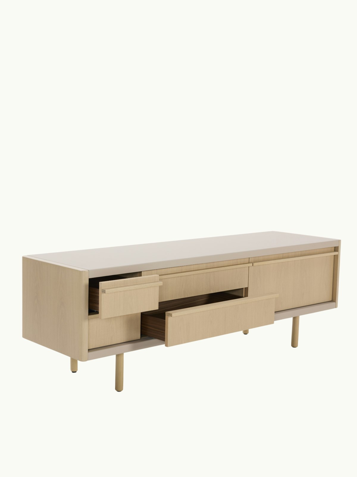 New Canaan Media Unit in Oak and Bristol Leather in Champagne with two open drawers, viewed at an angle on a white sweep.