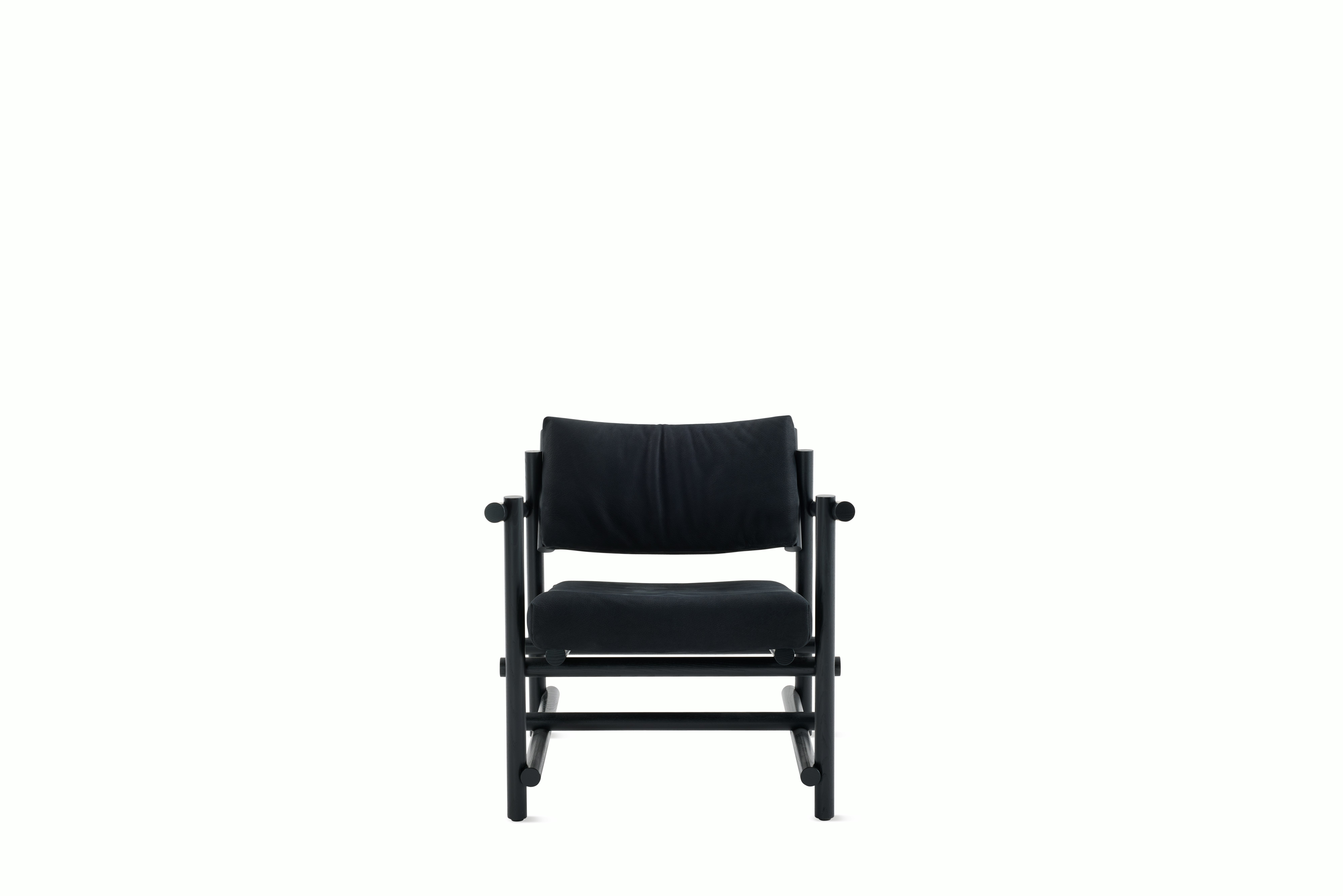 A Muecke Lounge Chair in Lava Black Ebonized Ash viewed from the front.