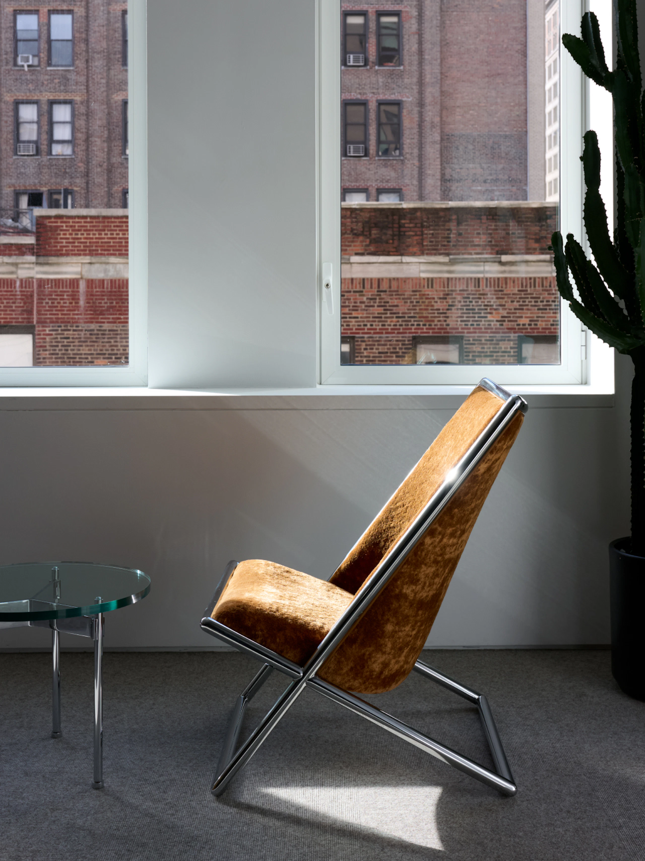 Scissor Chair by a Claw Table.
