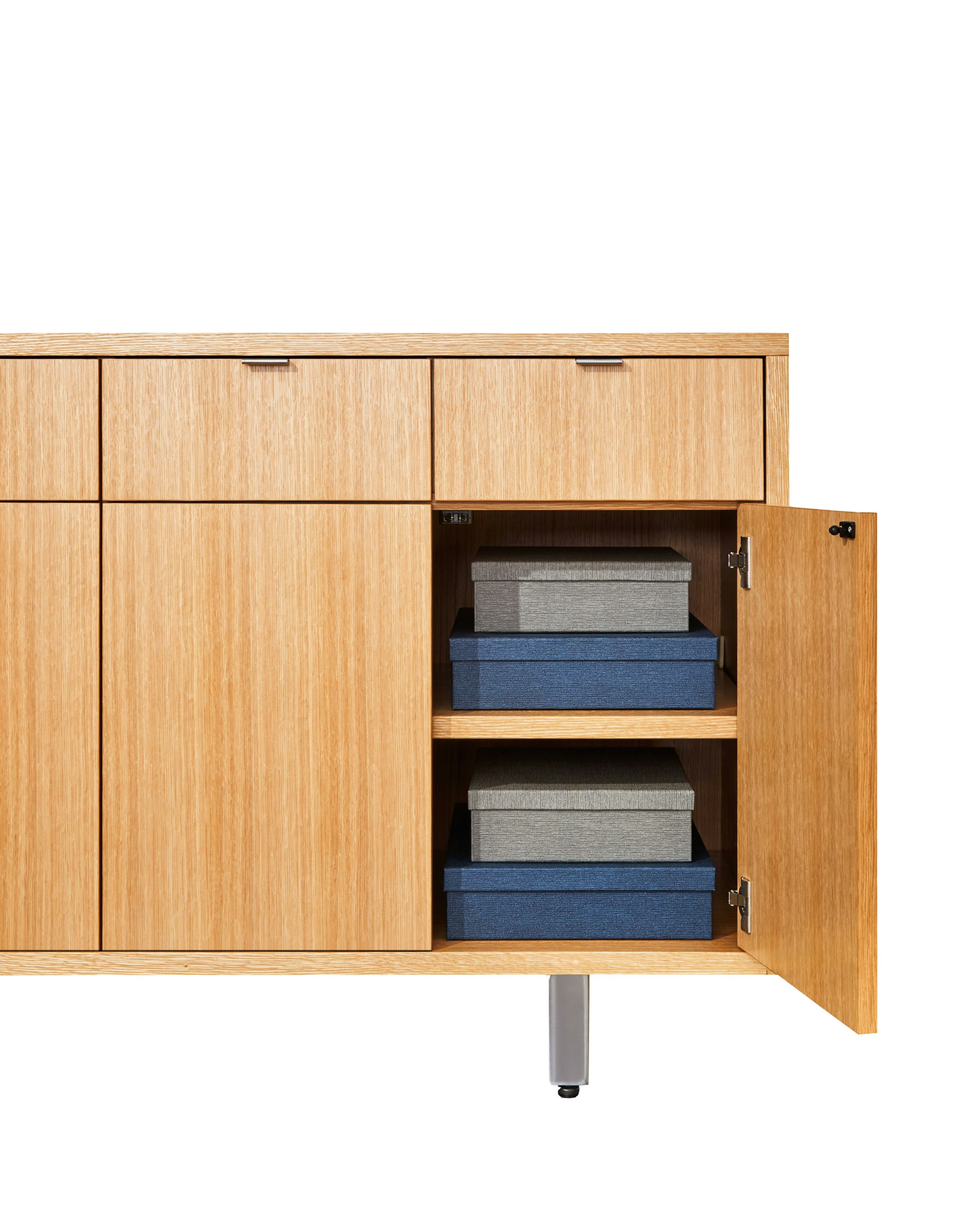 Highline 25 Credenza in Rift Cut European White Oak, open cabinet detail with boxes, front view.