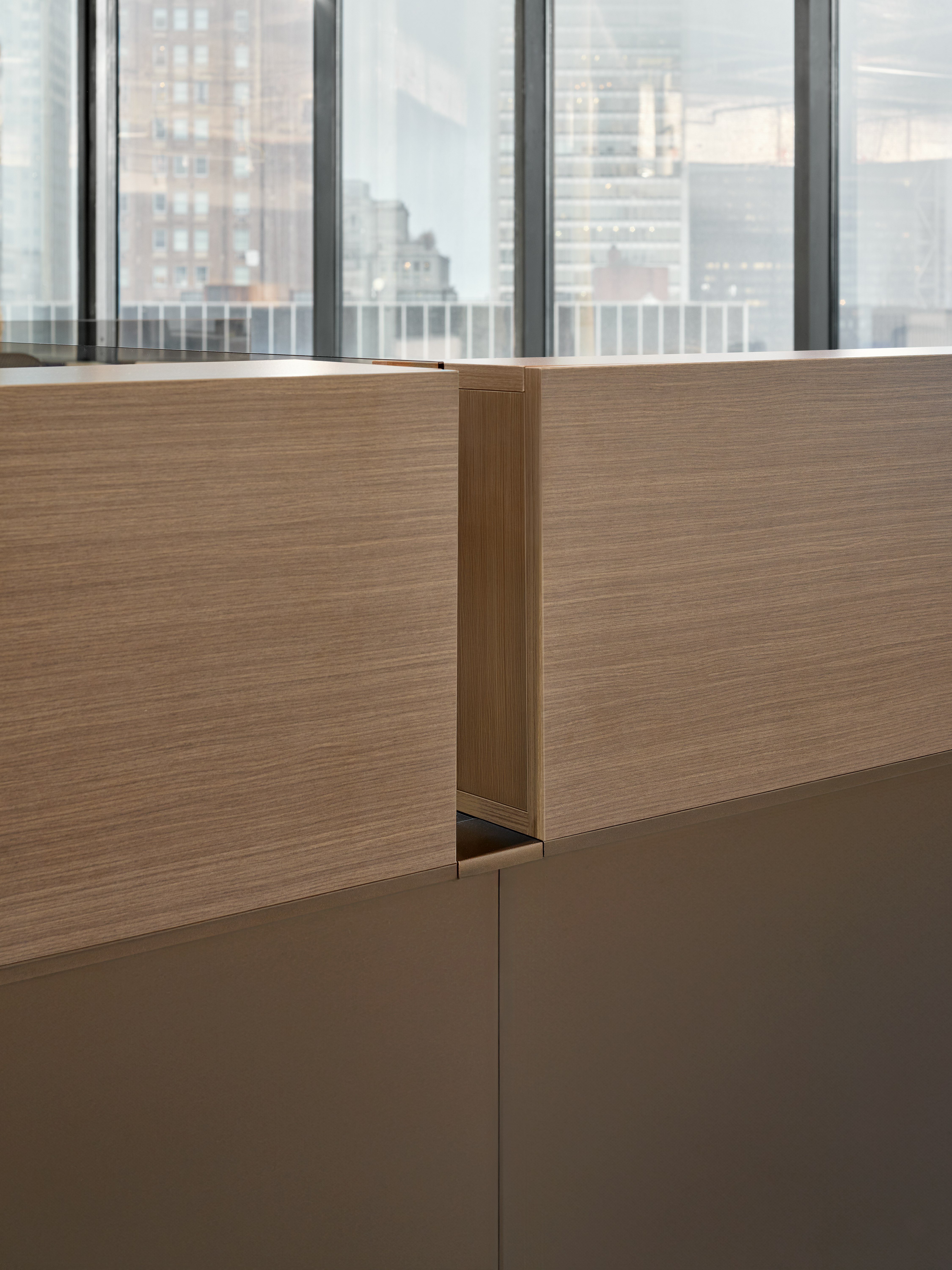 This detail style image shows the backside of desk mounted cubbies and the system panels they are stacked on top of.