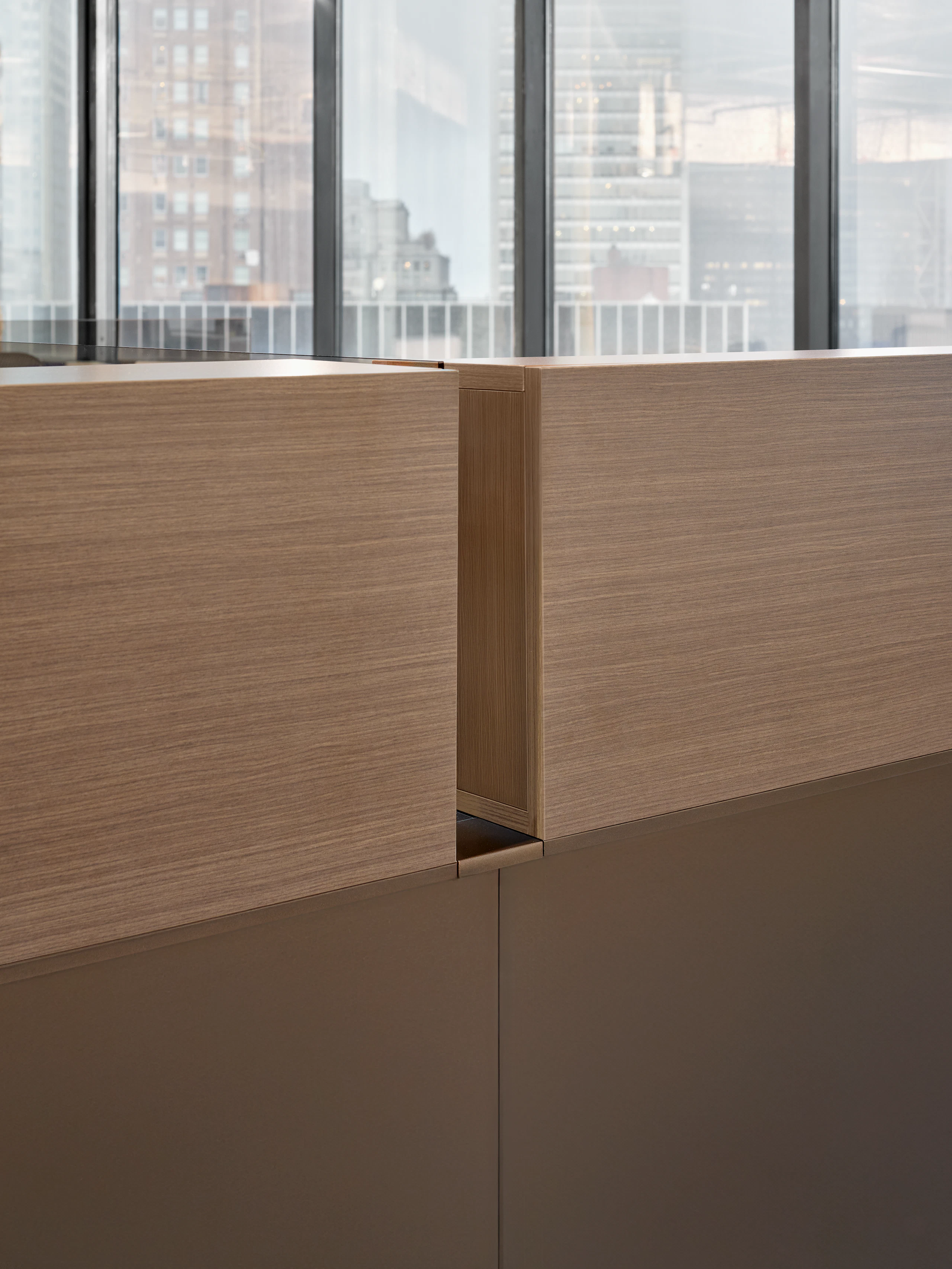 This detail style image shows the backside of desk mounted cubbies and the system panels they are stacked on top of.