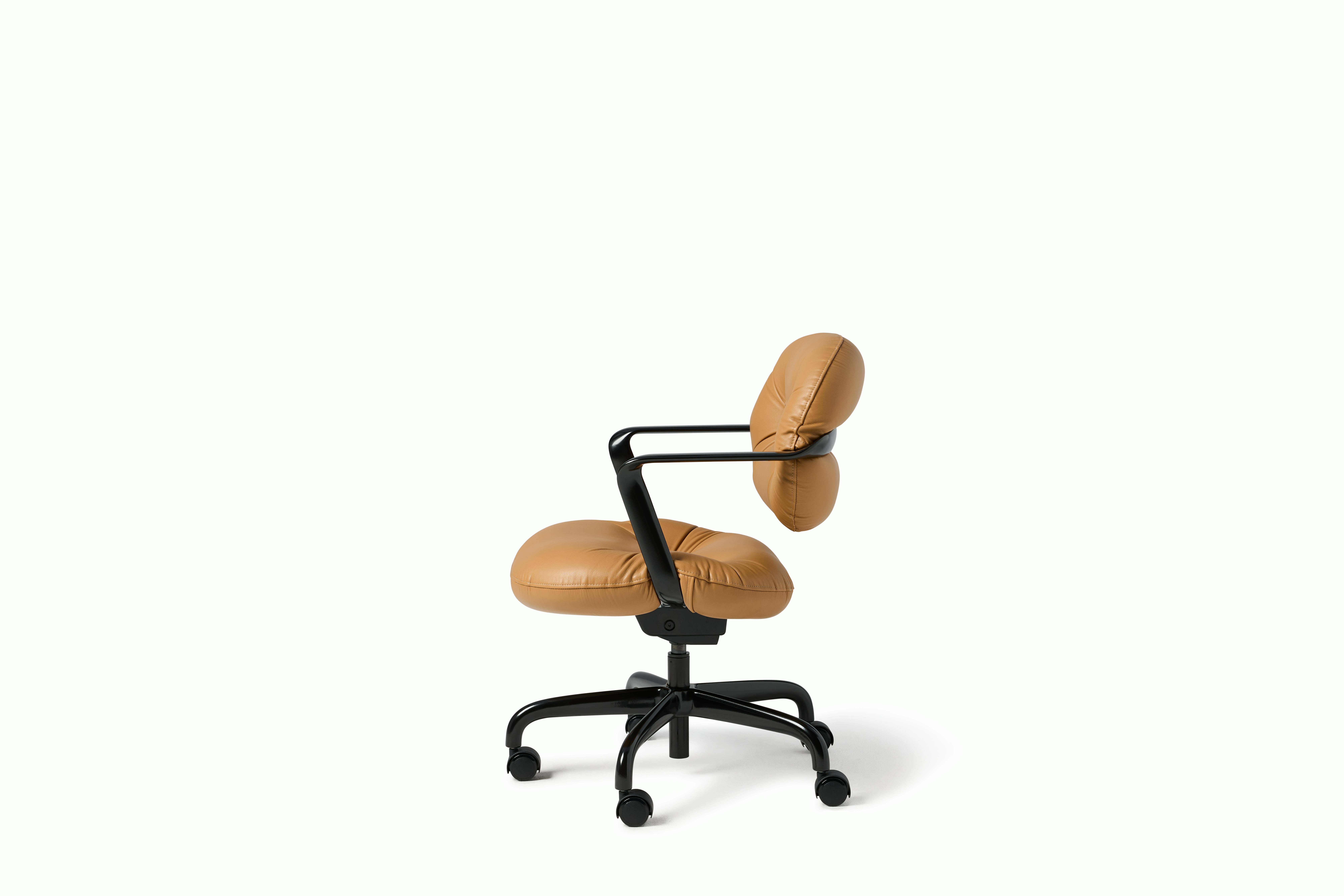 Side view of a Morrison Hannah chair with a black frame and base with fixed arms and light brown leather upholstery.
