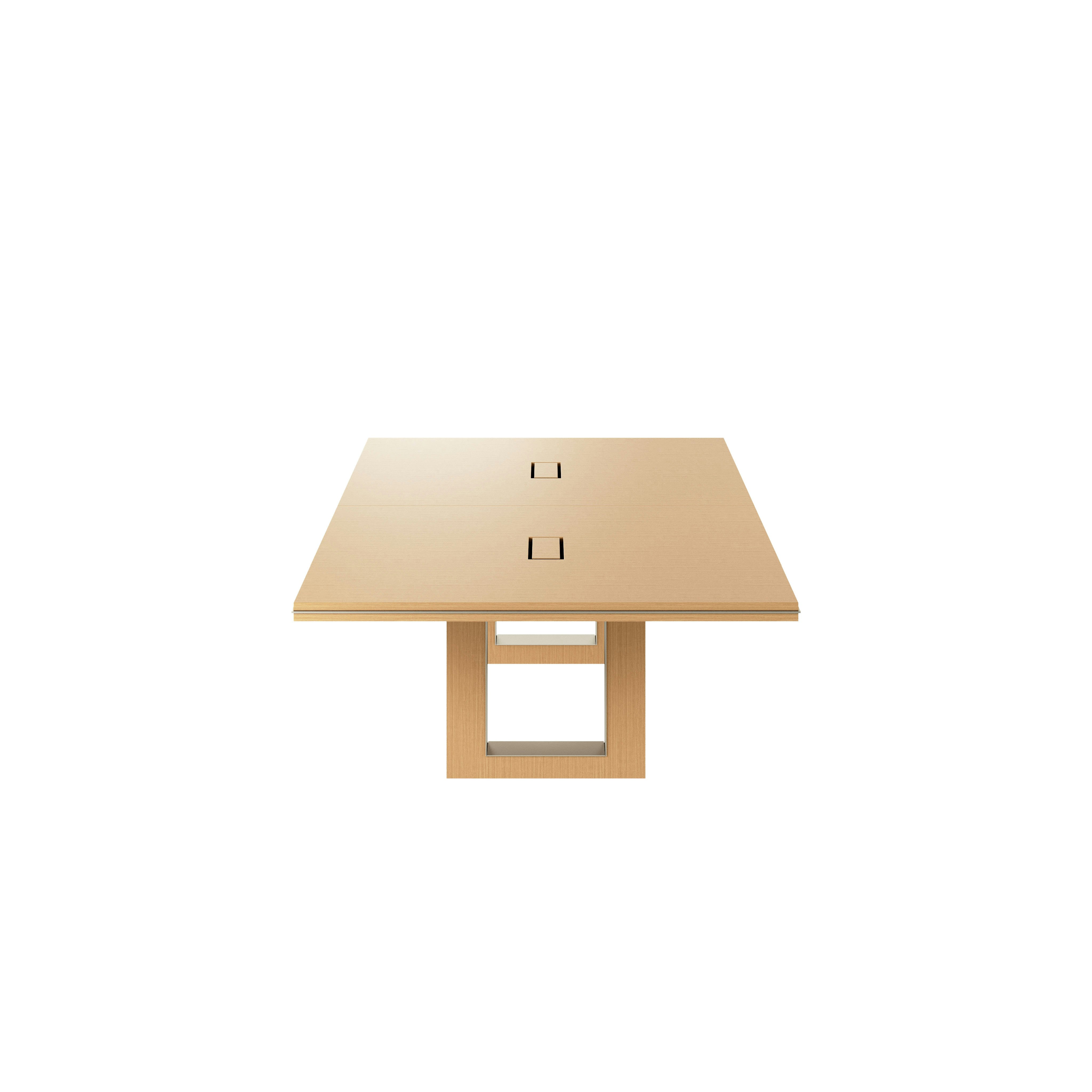 Rectangular Highline Fifty Conference Table in Natural Rift Cut Oak with a Satin Nickel edge and base trim viewed from the side.