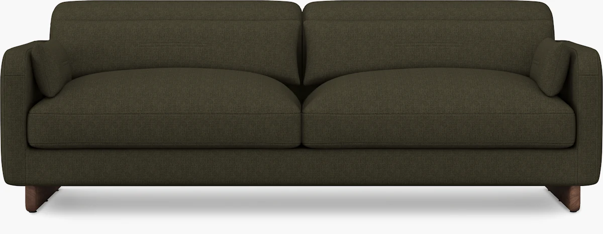Close-up of dark olive green sofa fabric and wooden legs