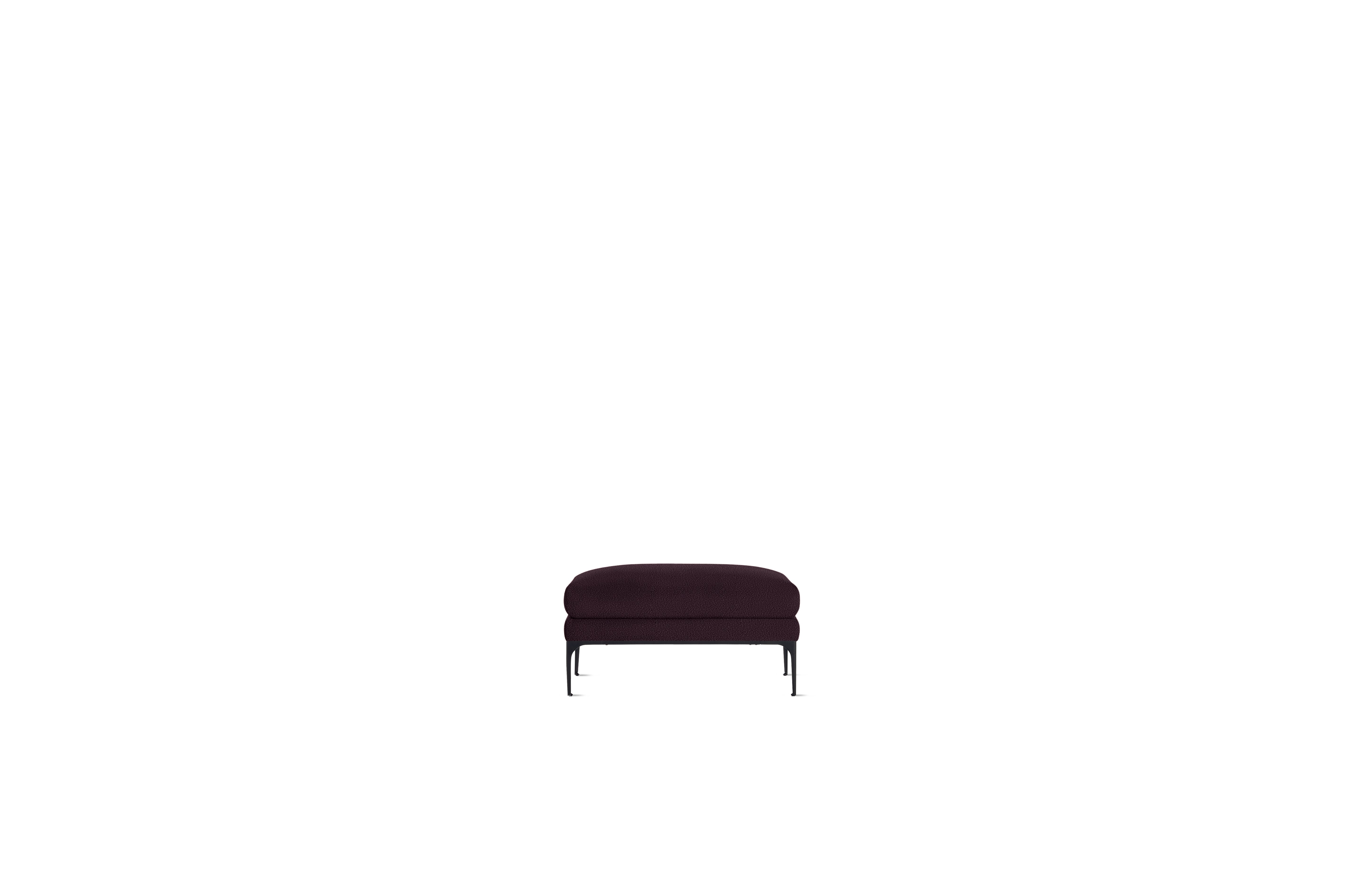 A Jonas Ottoman in Turf, Burgundy with Black finish viewed from the front.