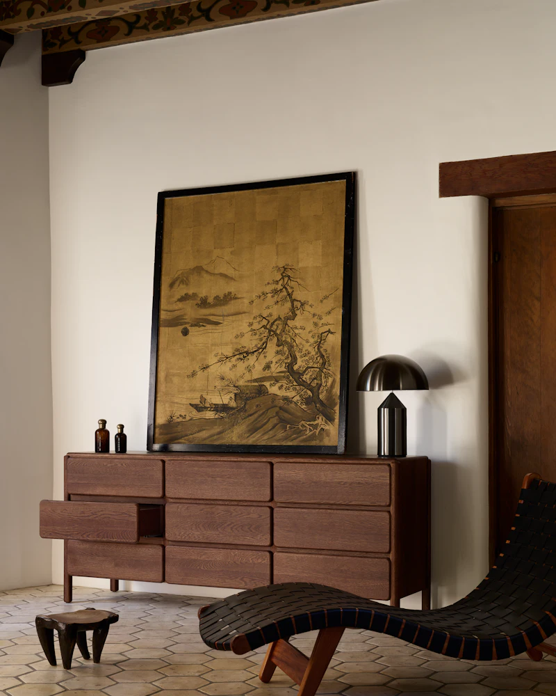 Dresser in living room setting with art