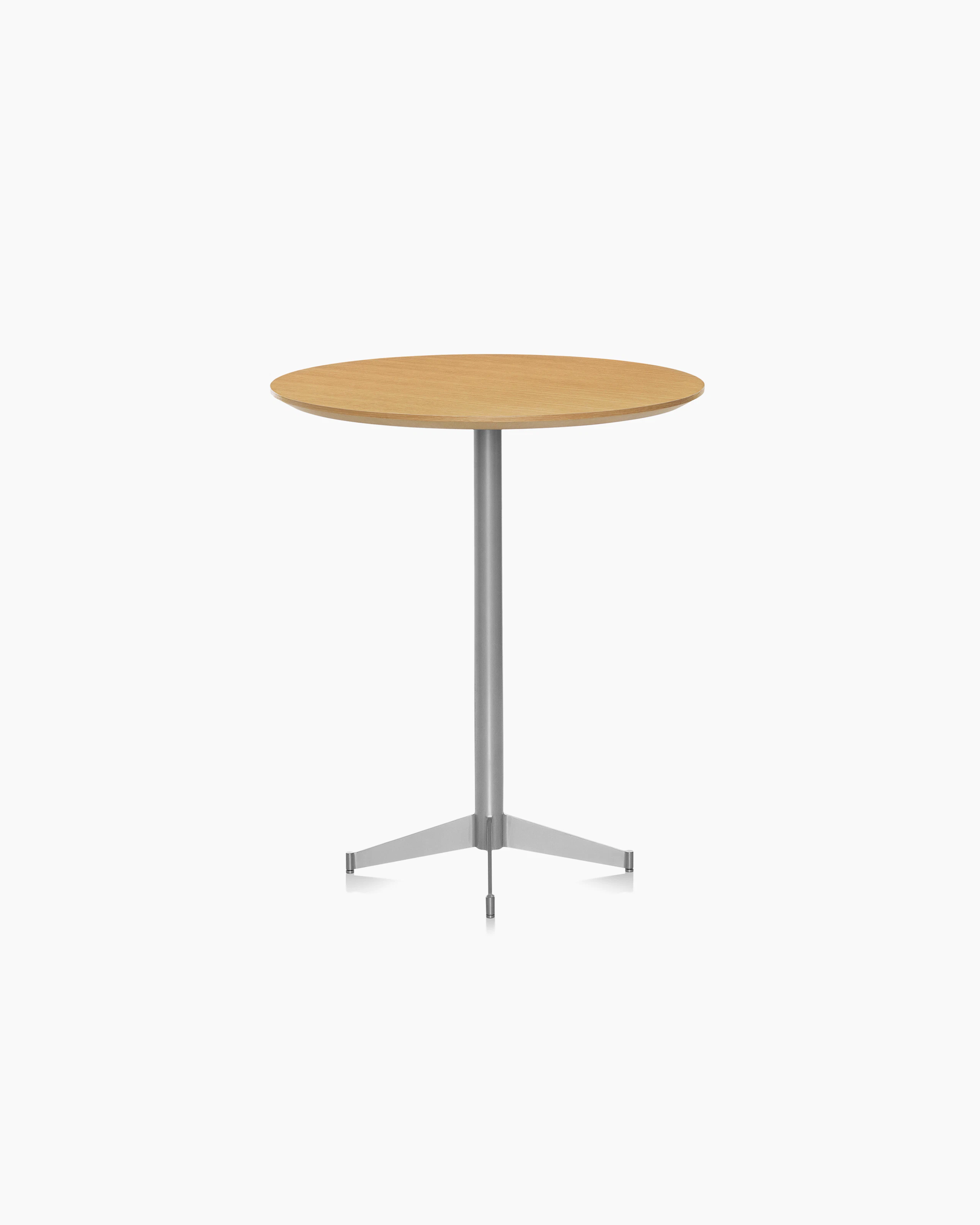 A café-height MP bistro table with a round wood top in a light finish.