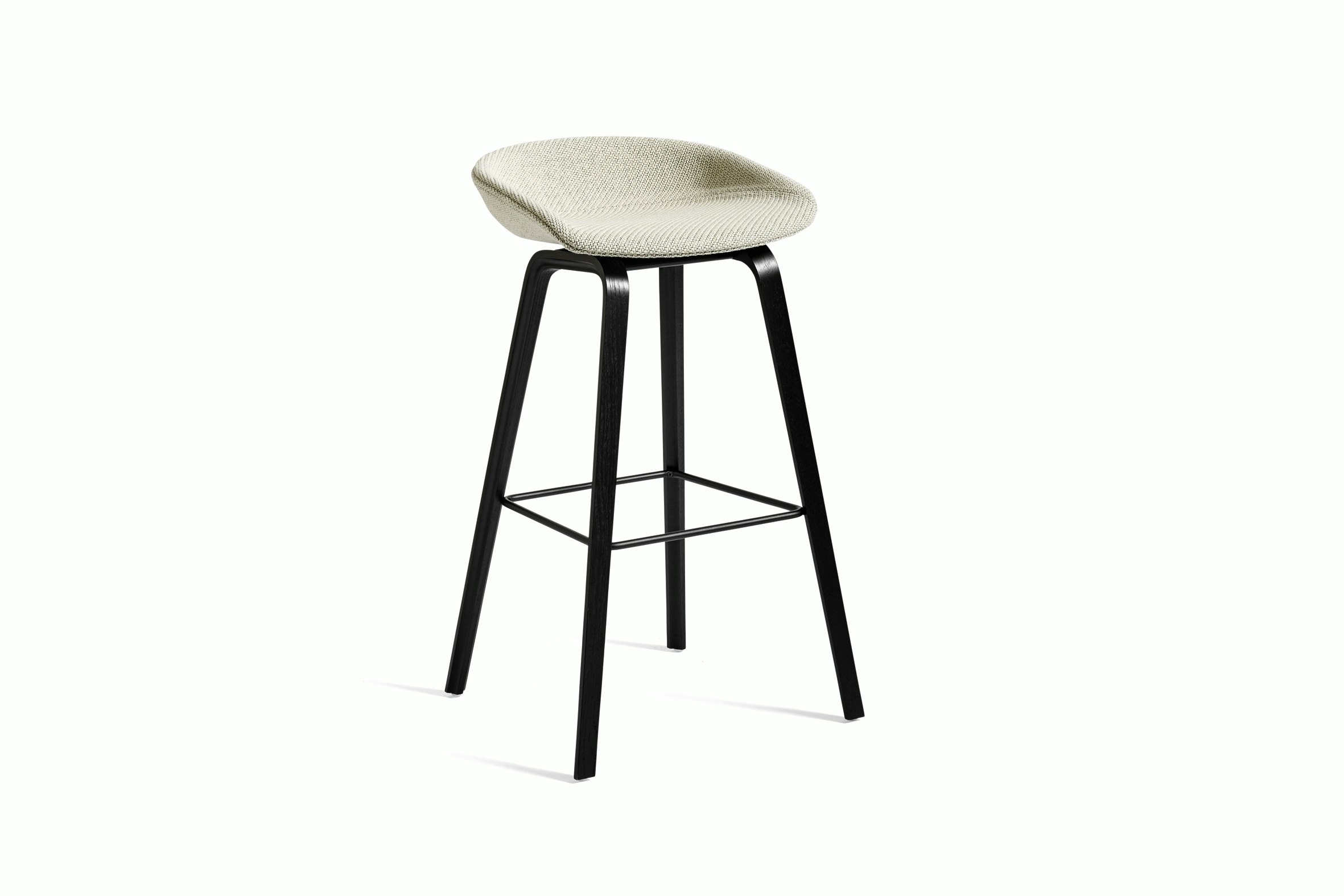 Off-white upholstered About A Stool with black wooden base, viewed at an angle.