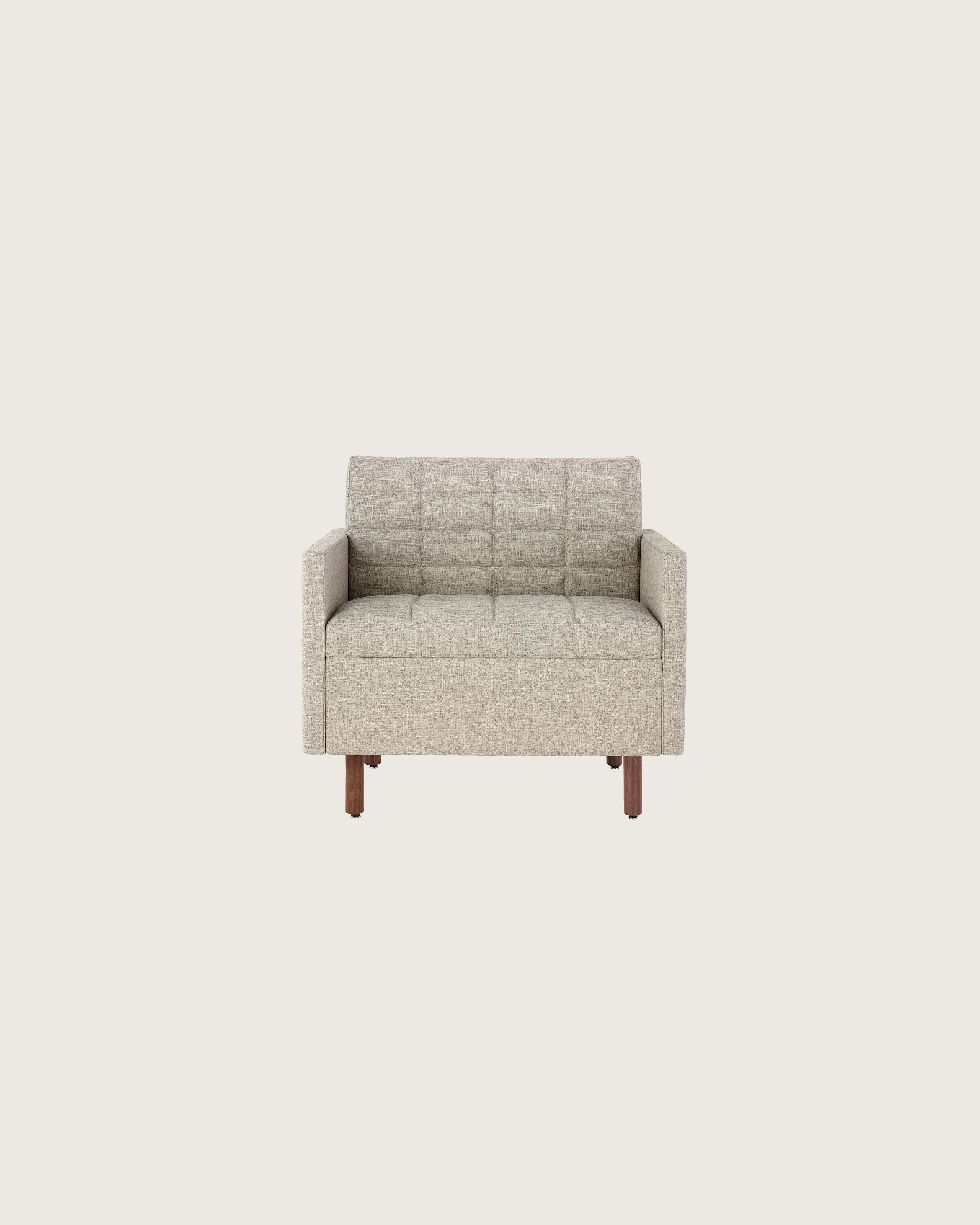A Tuxedo Classic club chair with bone-colored quilted upholstery, viewed from the front.