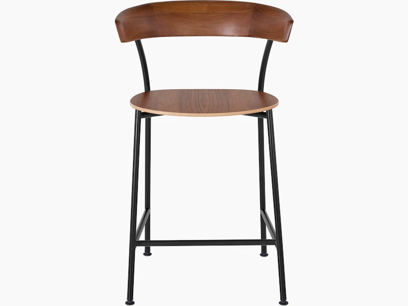 A Leeway Stool with a black metal frame and a wood backrest and seat in a medium finish, viewed from the front.