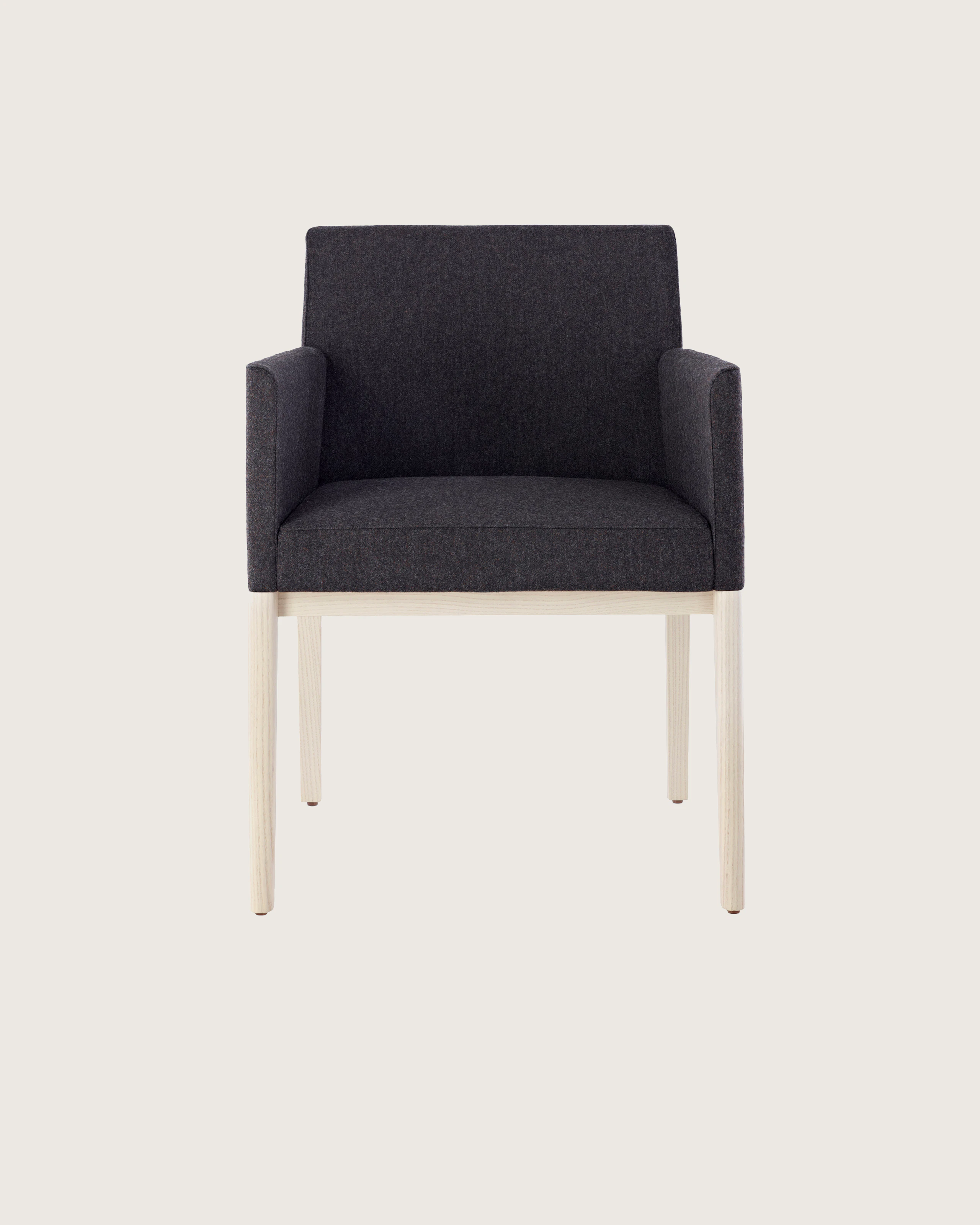 A Nessel side chair with black fabric upholstery, wraparound arms, and a wood frame with a light finish, viewed from the front.