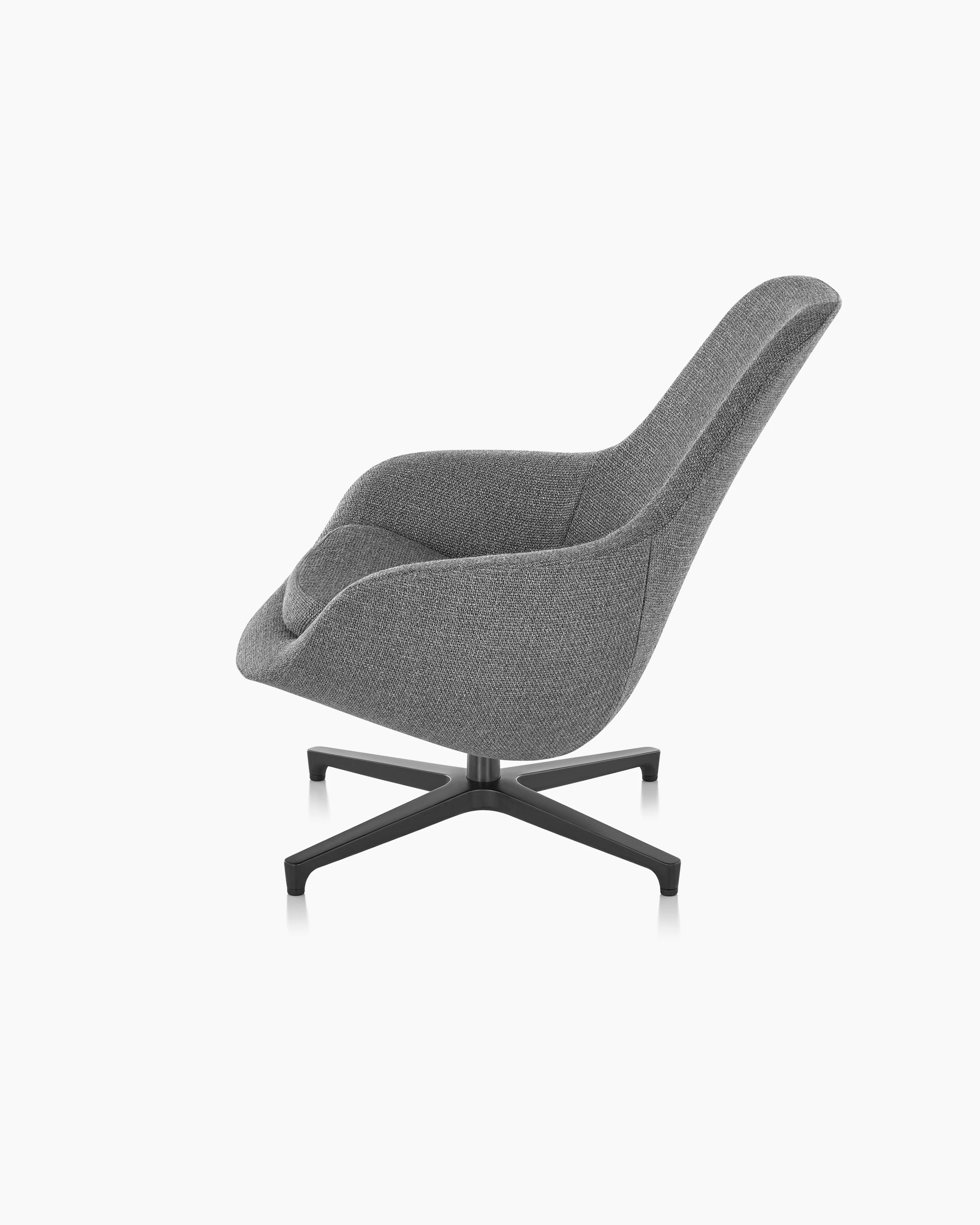 Partial side view of a Saiba Lounge Chair with gray upholstery, showing the impeccable tailoring.