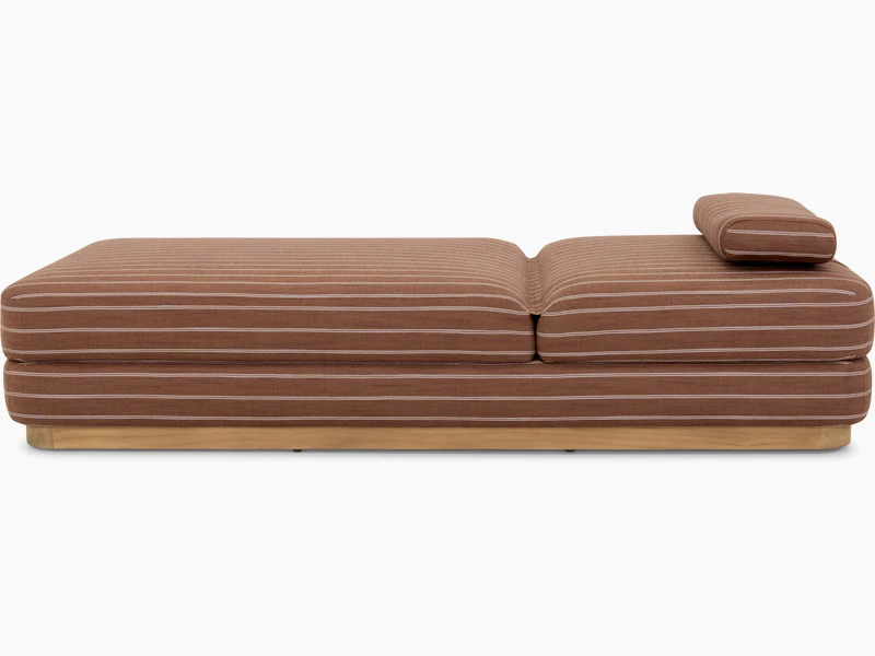 A Stack Outdoor Chaise in Terra Rossa viewed from the side.
