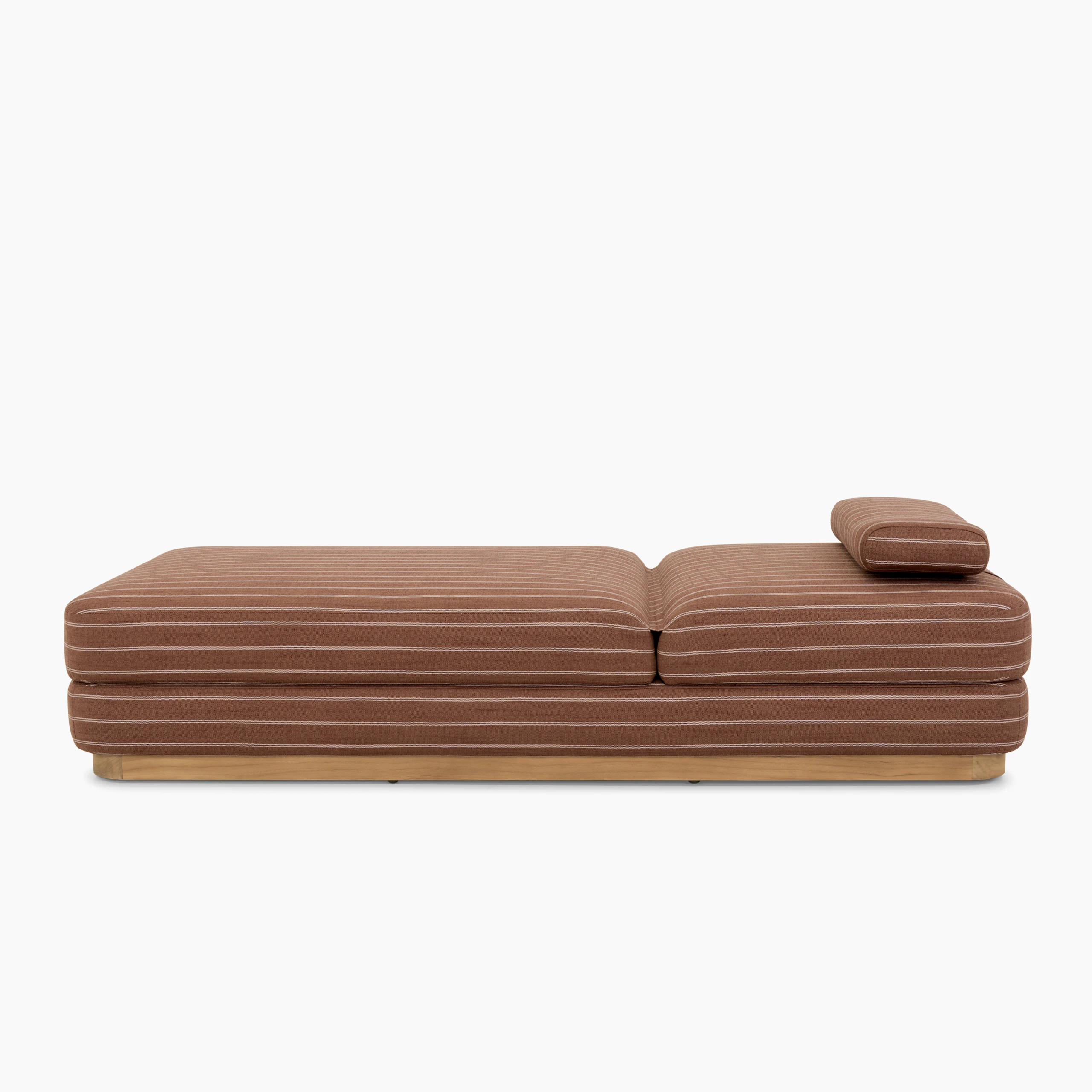 A Stack Outdoor Chaise in Terra Rossa viewed from the side.