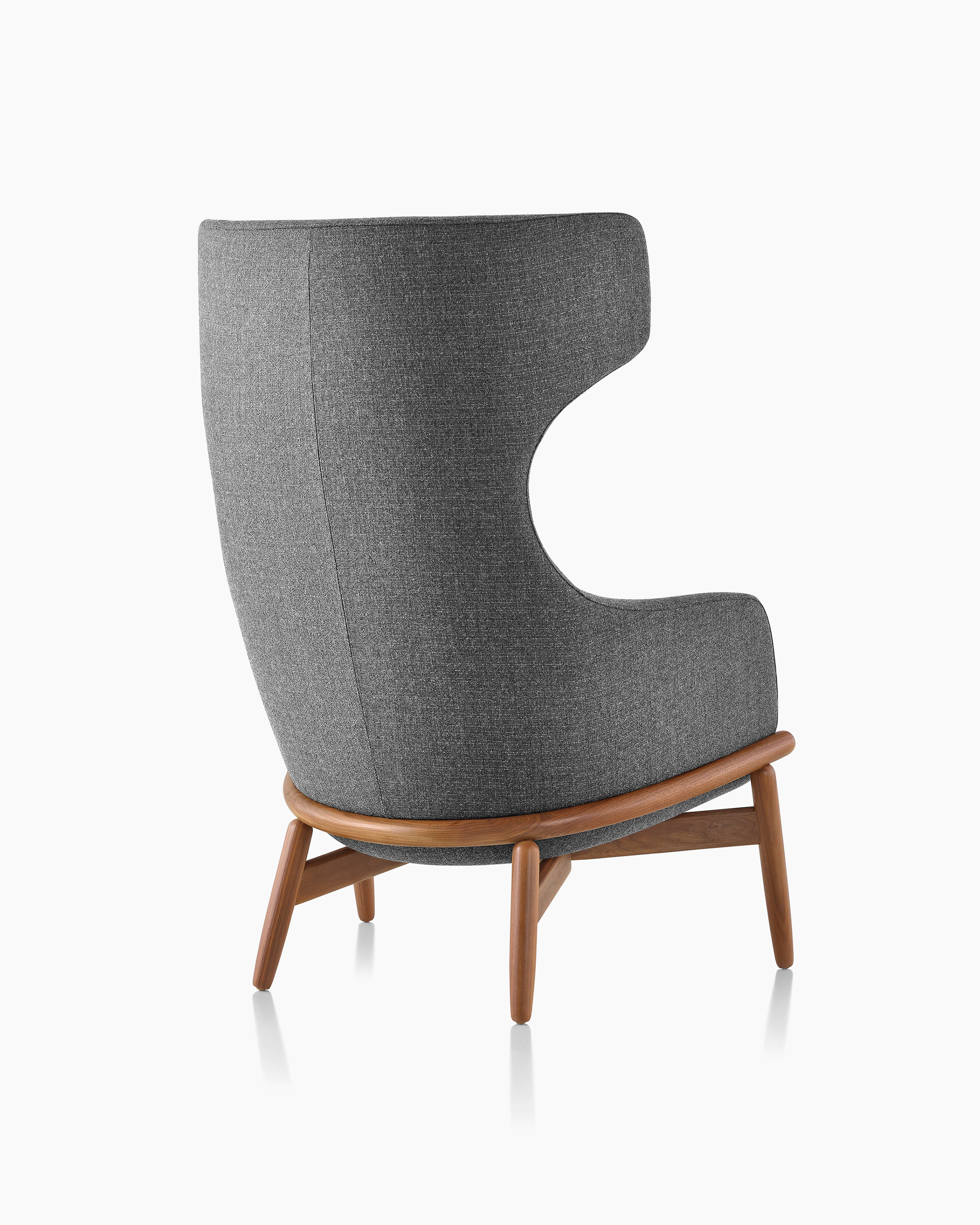 A wing-back Reframe Lounge Chair in Milaner Charcoal, viewed from behind.