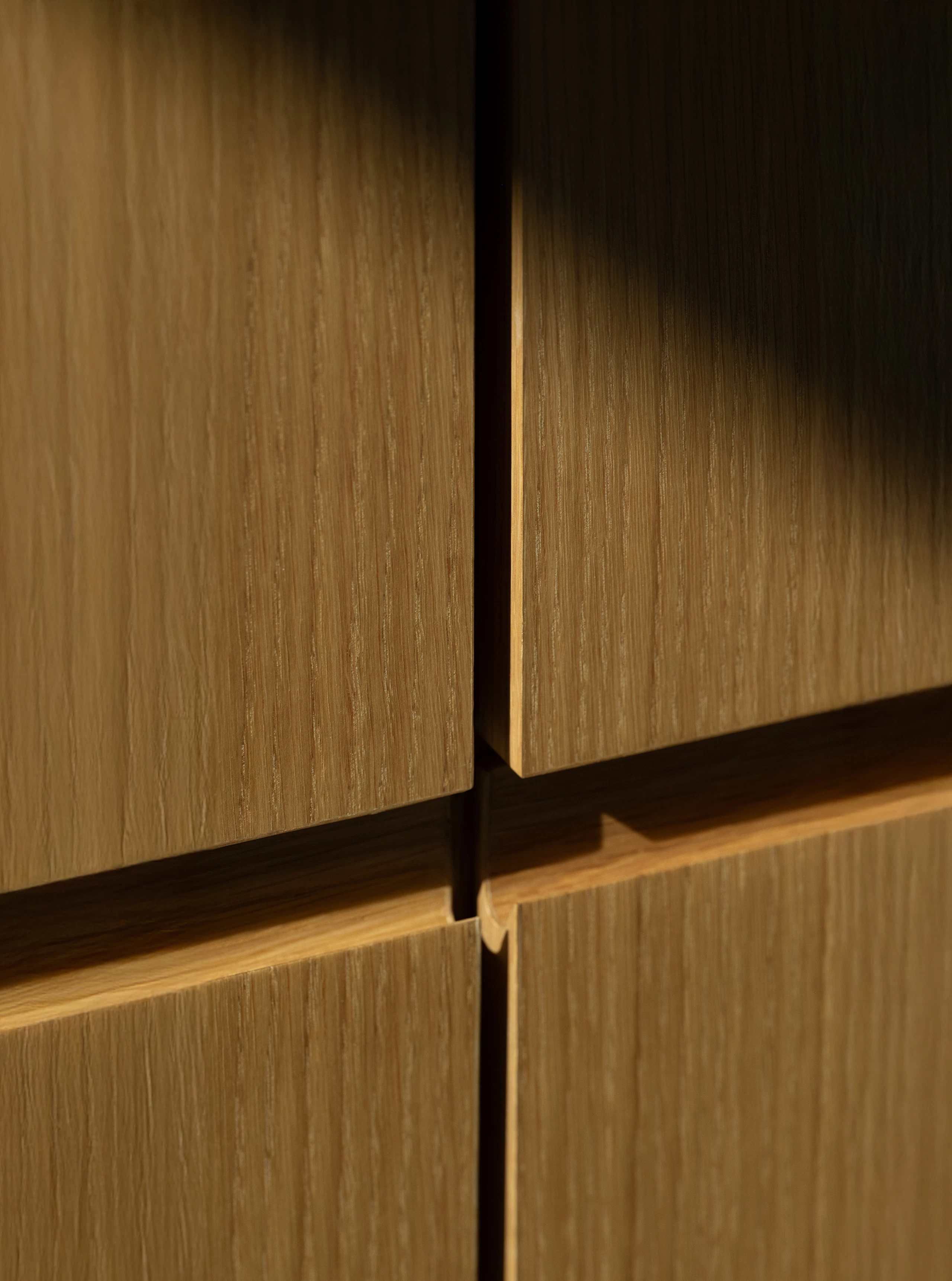 Detail view of the drawers on a custom Geiger file bank in Natural Rift Cut Oak, viewed at an angle.