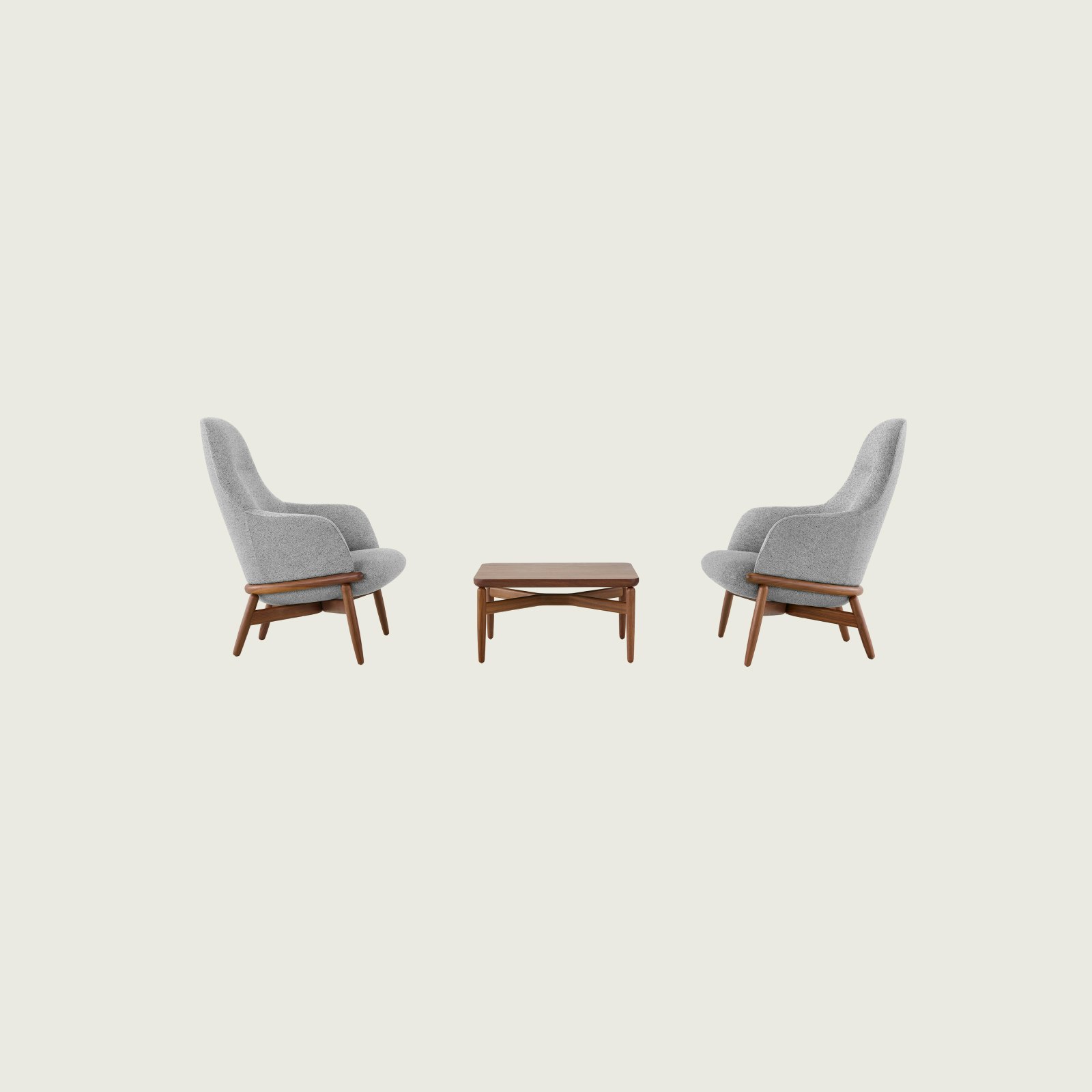 Two gray upholstered Reframe High-Back Lounge Chairs on either side of a walnut Reframe Table.