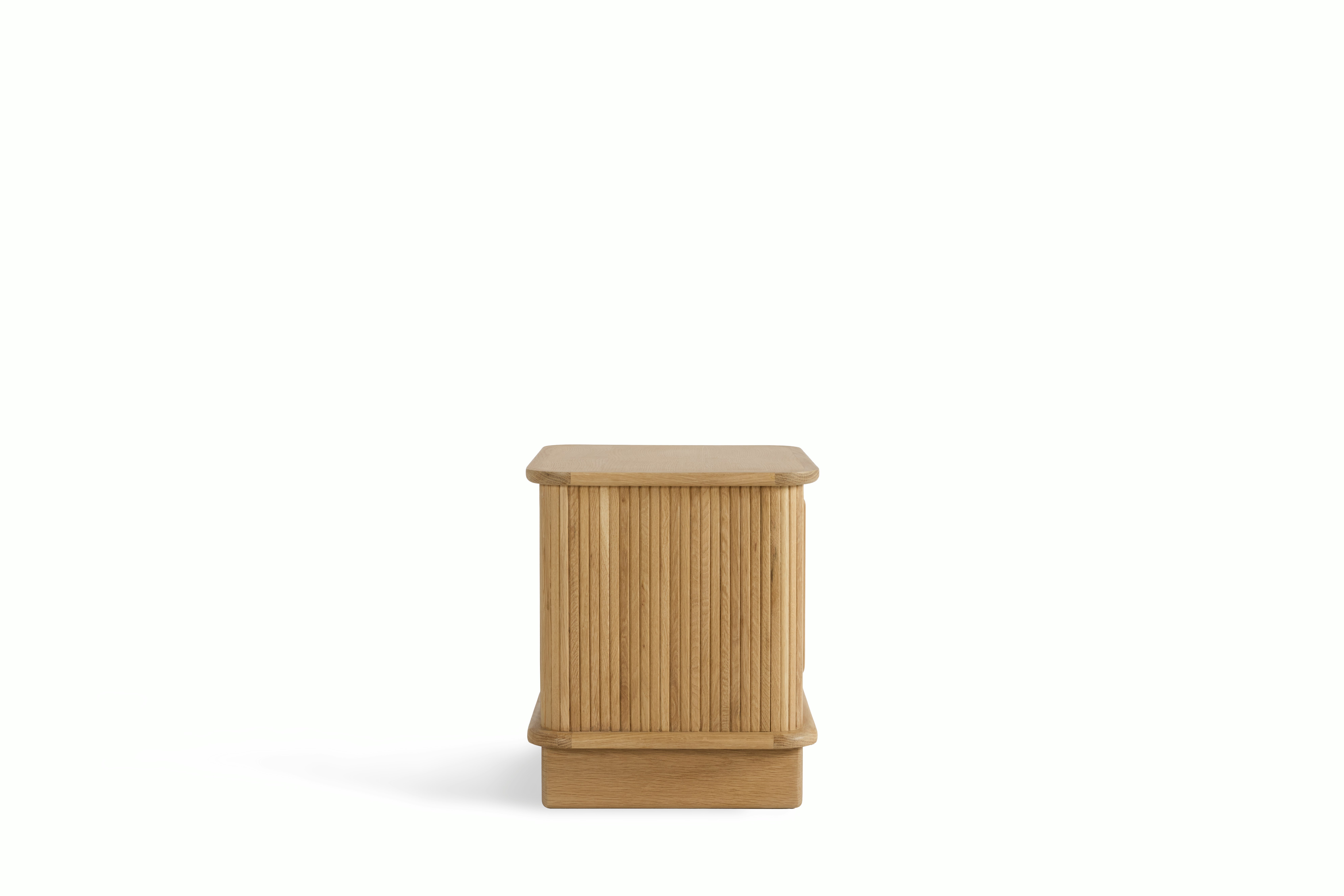 A Noviembre Bedside Table in Oak viewed from the side.