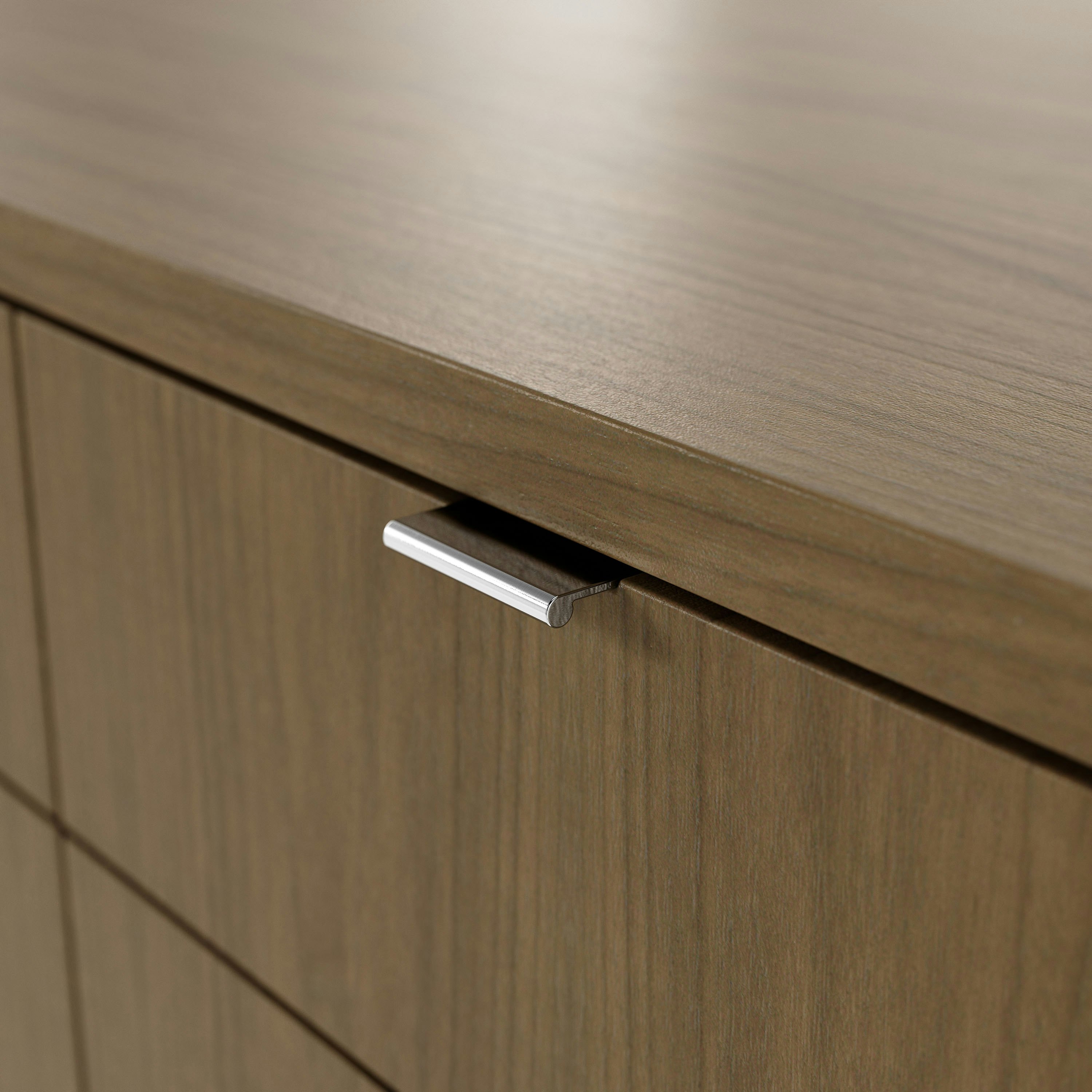 Detail shot of closed box drawer on Highline Twenty Five Credenza in Natural Flat Cut Walnut with Polished Chrome base and drawer pulls.