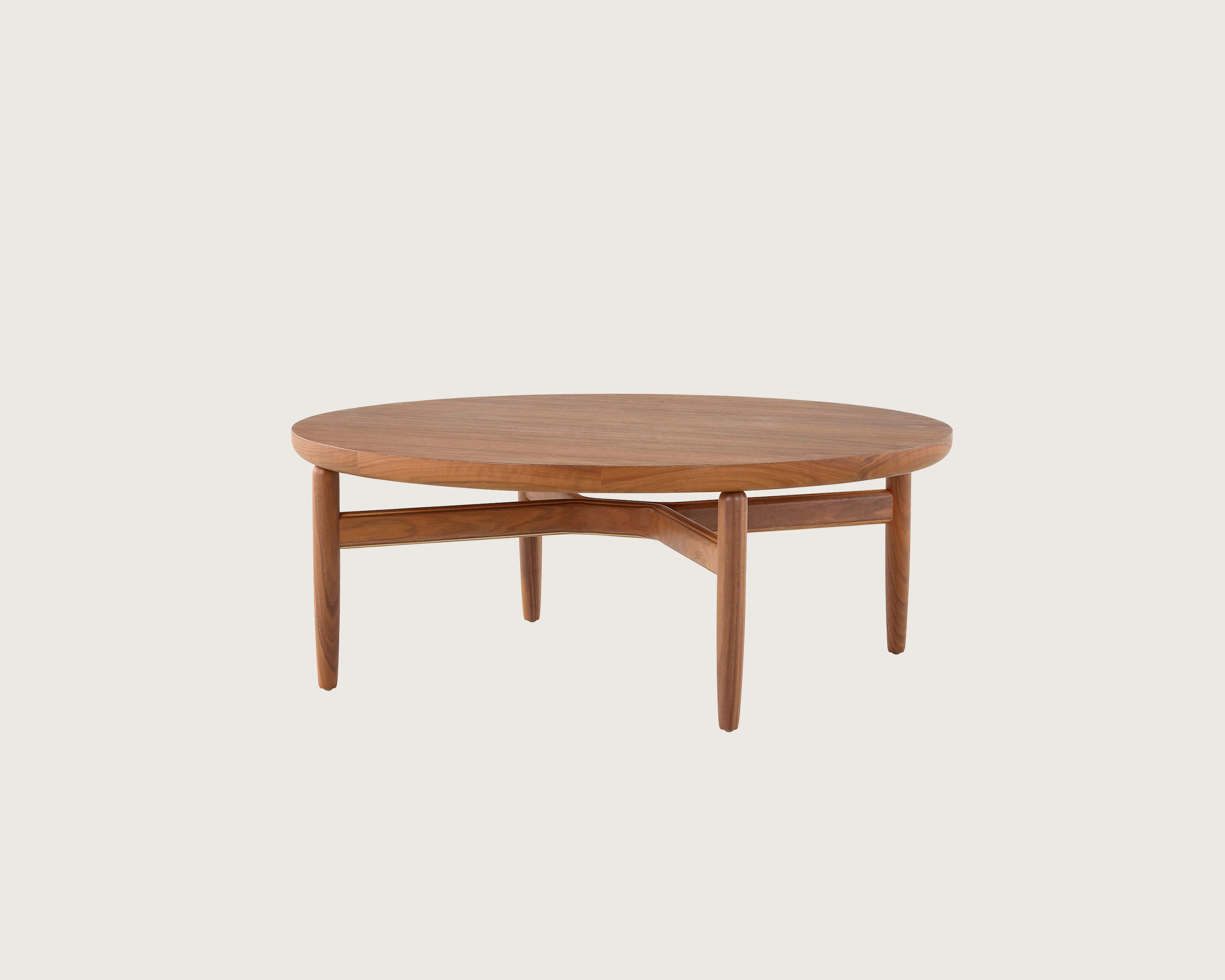 A Reframe Round Table in Walnut, viewed from a three-quarter perspective.