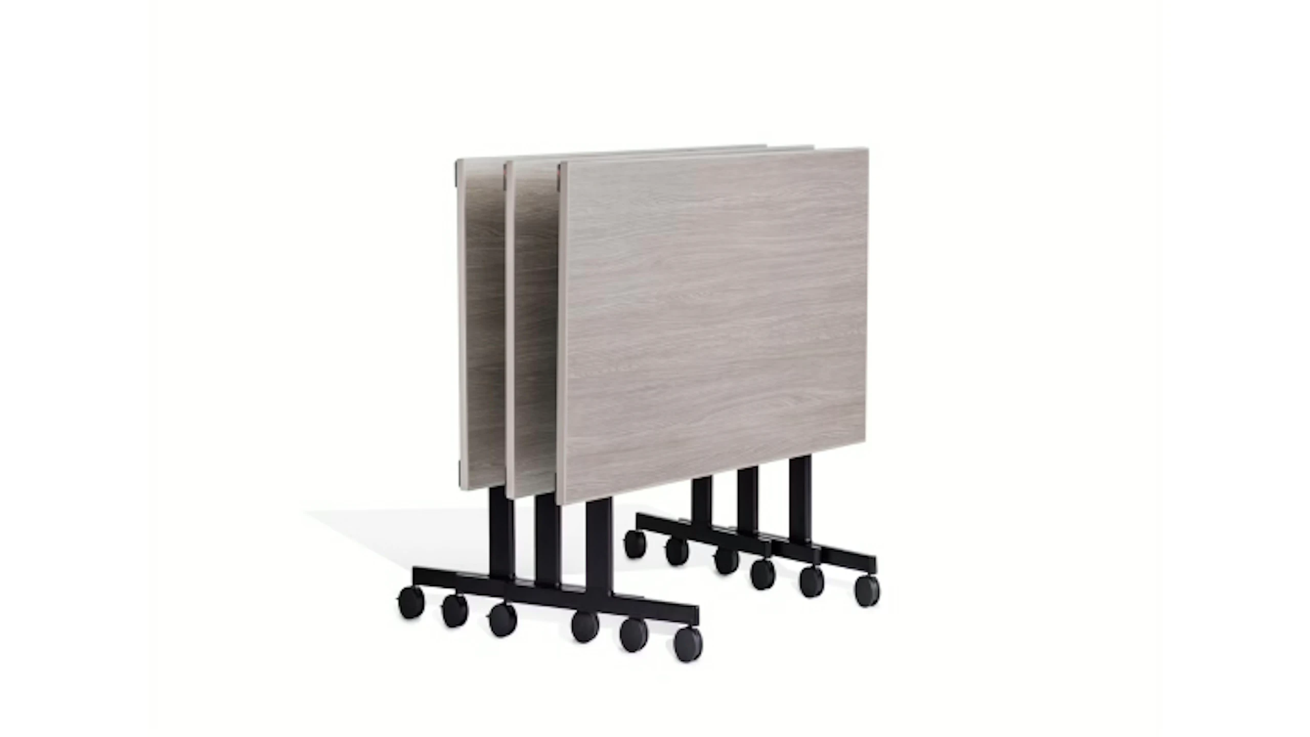 Stacked rectangular Pixel C-Leg Tables by Knoll with light wood tops and black metal bases on casters.