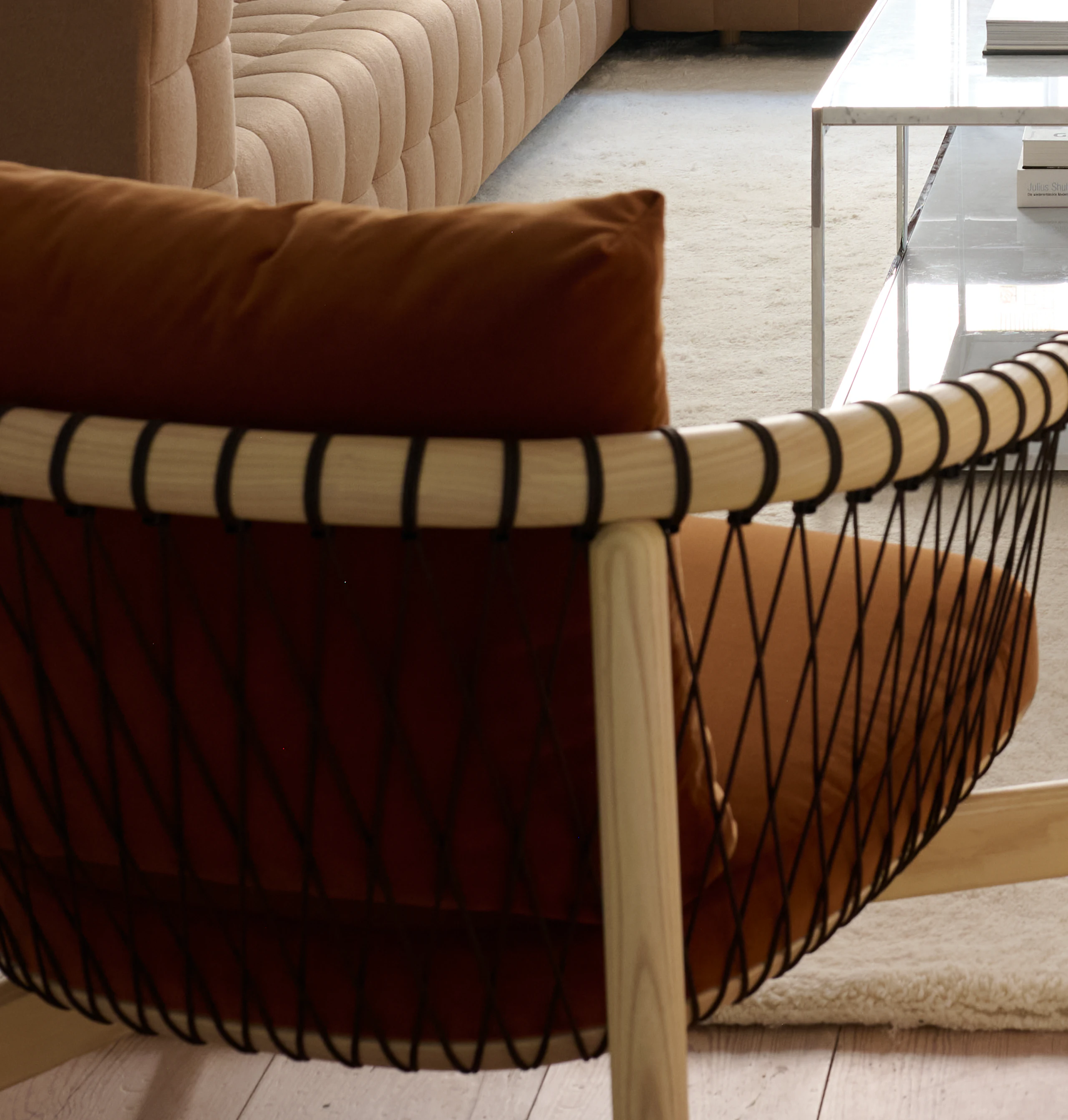 Lounge setting with a Rapport Sectional Sofa, Tuxedo Component Club Chairs, and Crosshatch Lounge Chair around two H-Frame Coffee Tables.