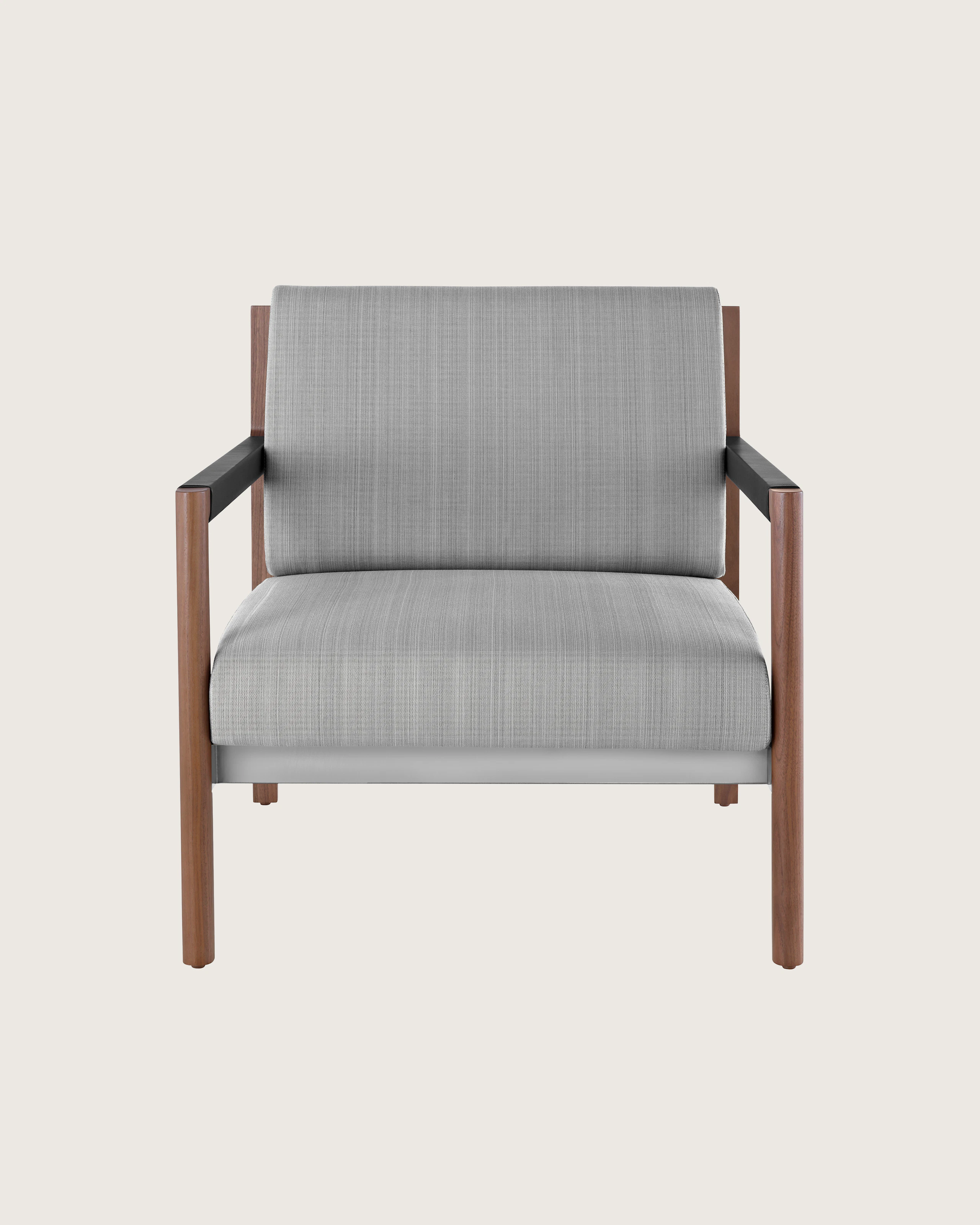 A Brabo Club Chair with light gray upholstery, leather and metal accents, and an exposed wood frame. Viewed from the front.